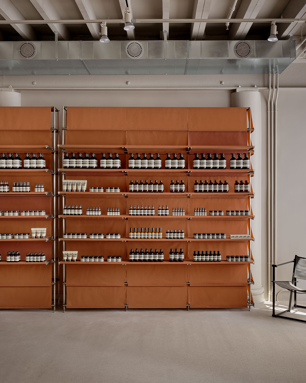 store interior of orange product shelves and grey concrete floor