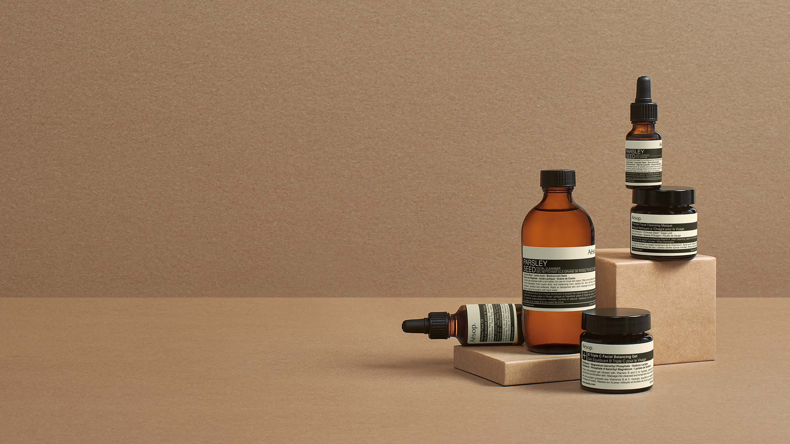 Aesop products in bottles brown background