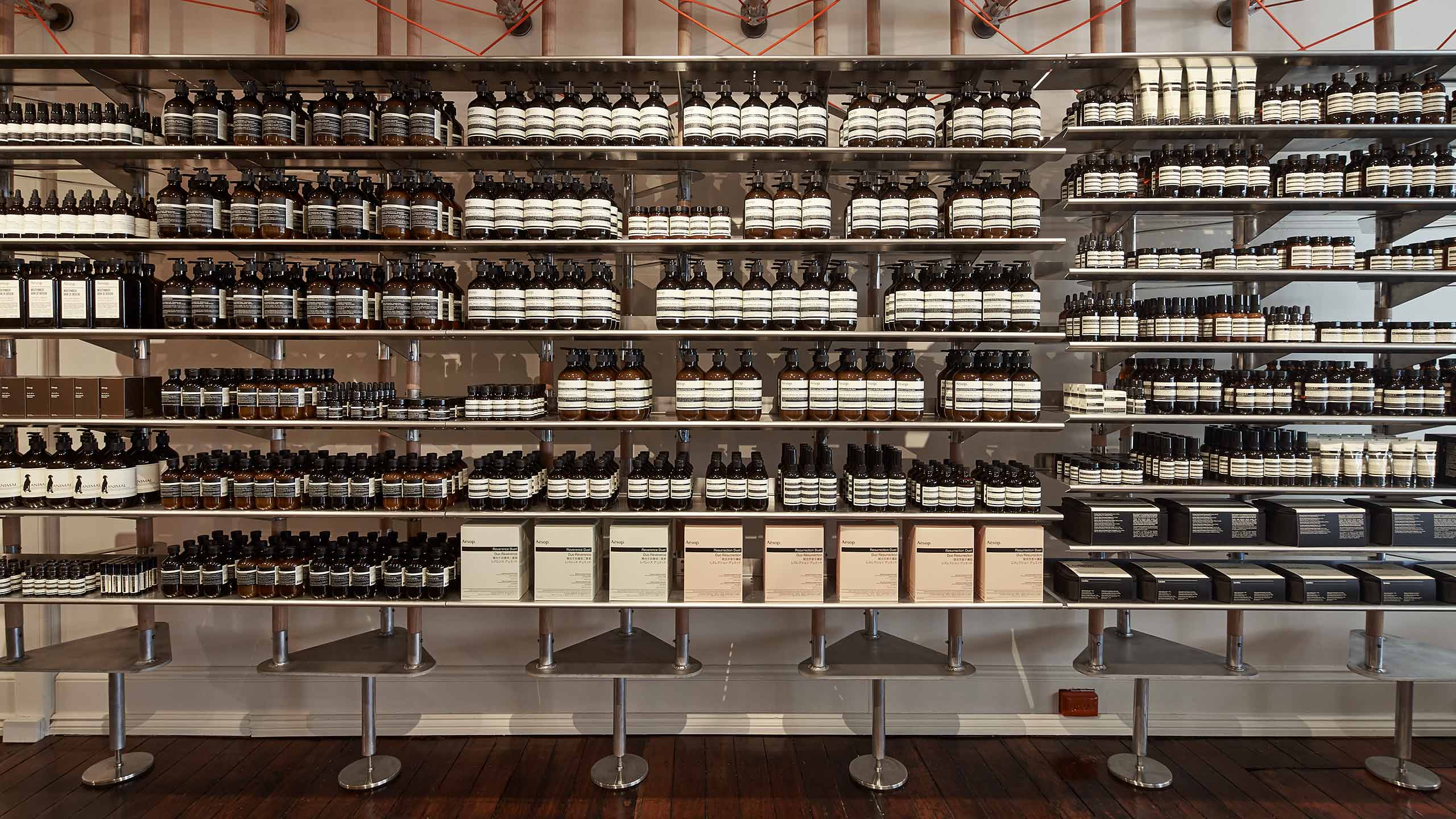 A close-up of the shelving units inside the store, lined with dark bottles.