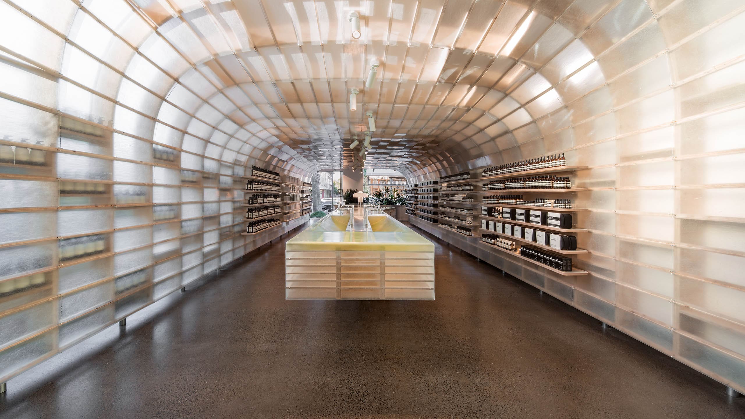 A large fibreglass sales counter, demonstration sinks and product storage grids.