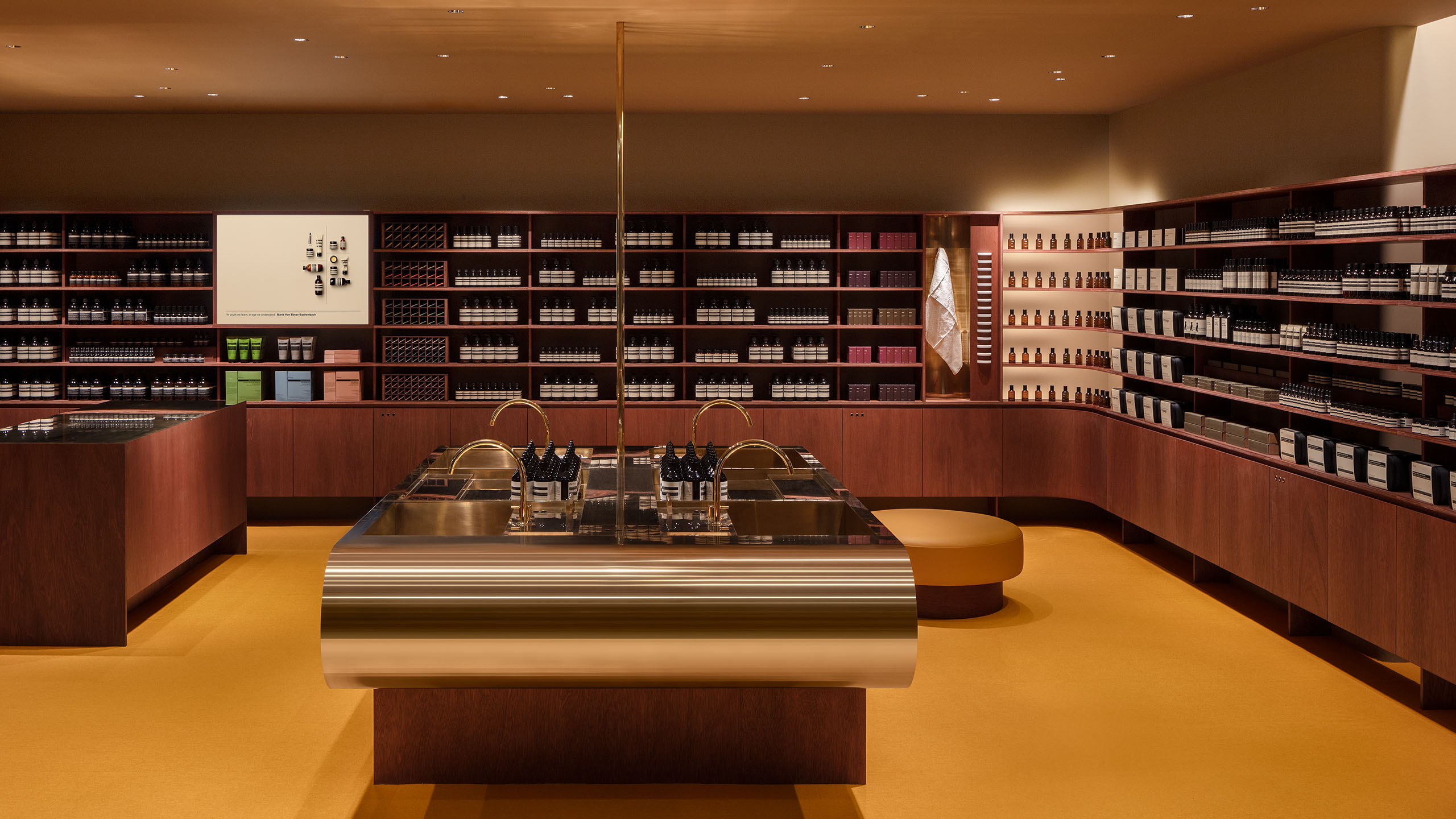 Aesop Kyoto Takashimaya interior with a central communal basin, fixtures and countertops in brass metal