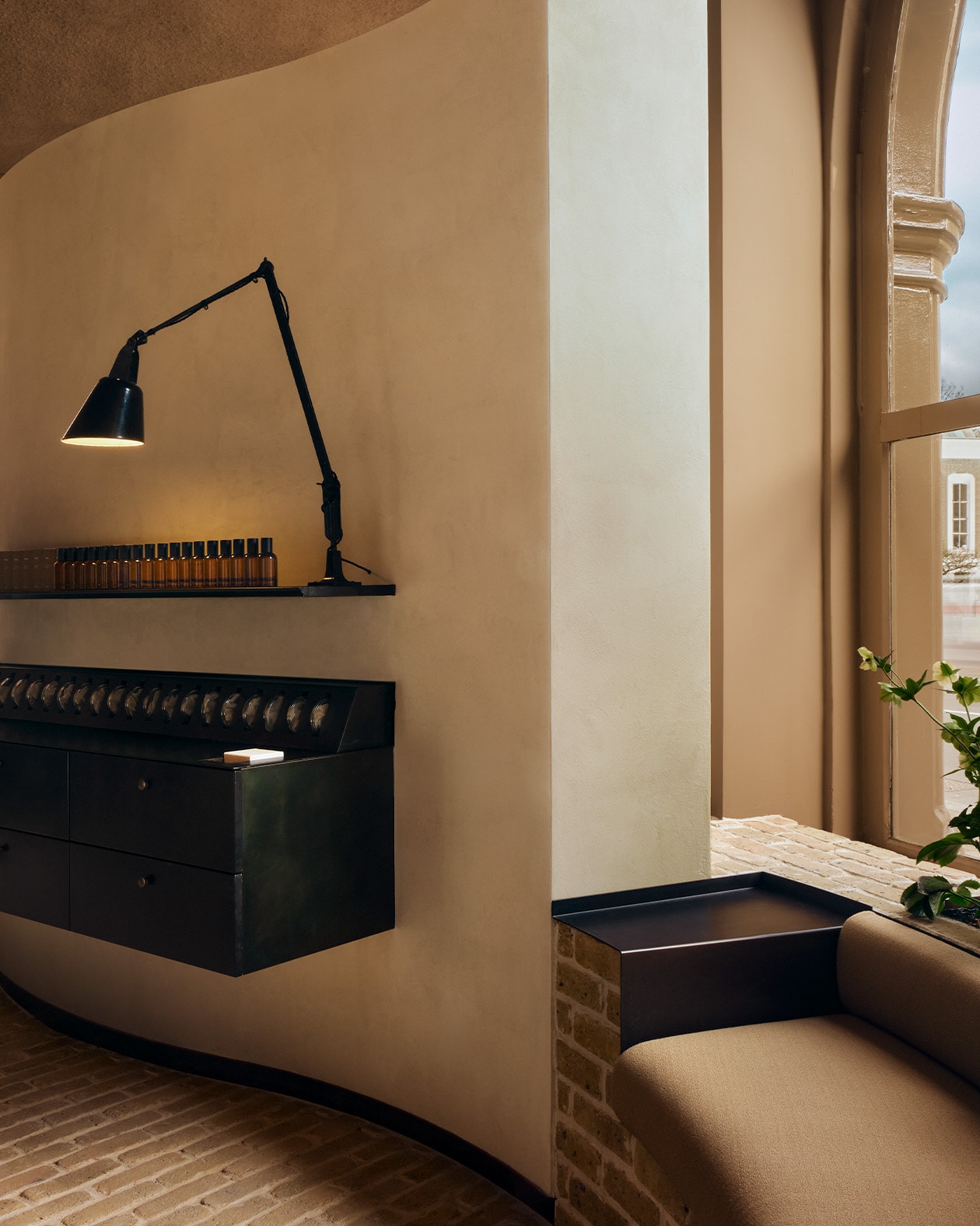 Aesop Islington store interior window seat, basin and lamp.