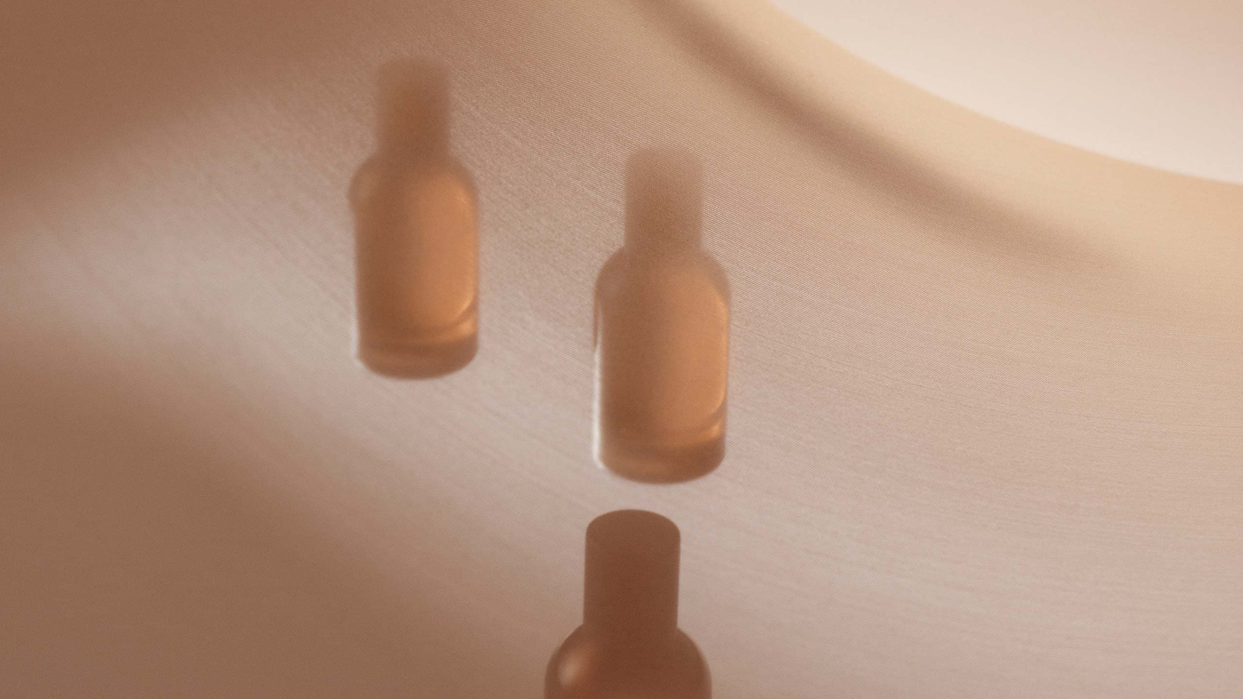 Three amber glass fragrance bottles