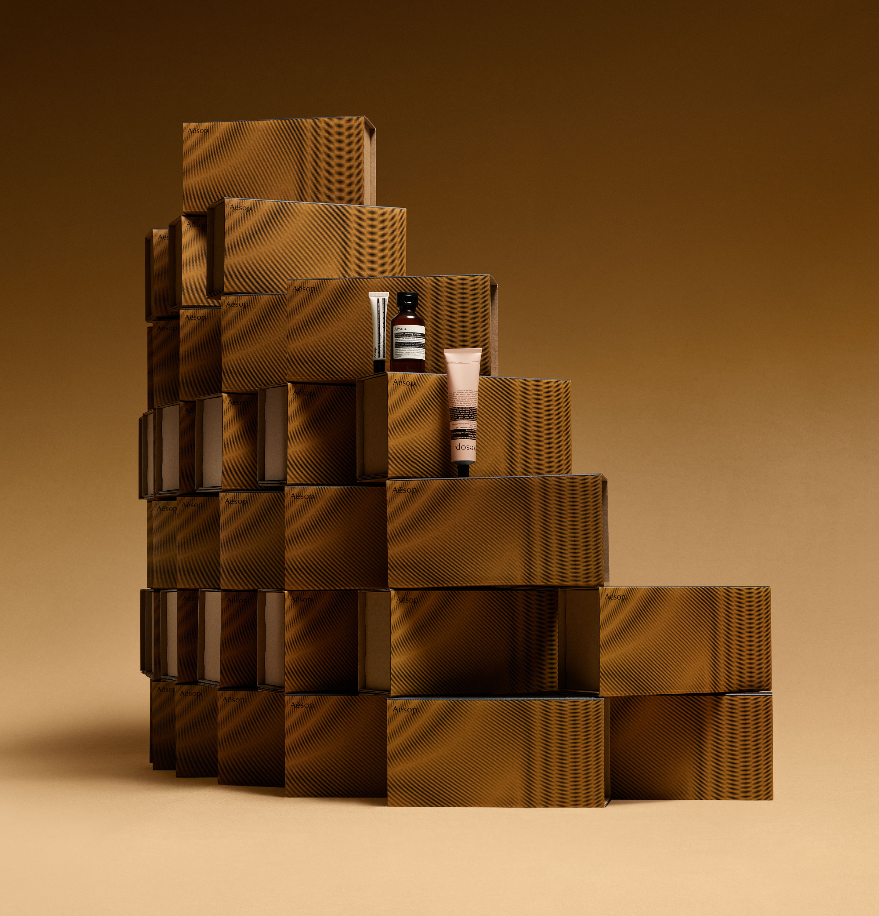 Aesop products placed on stacked brown cardboard boxes