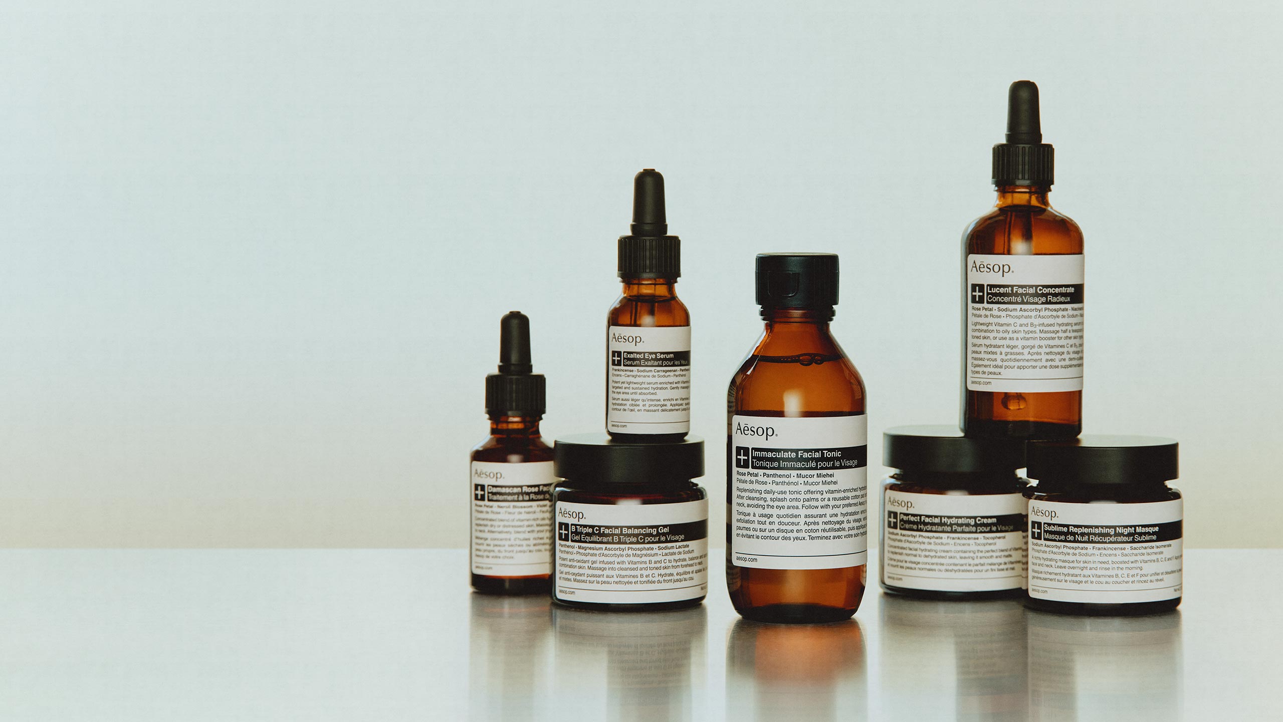 Aesop skincare plus range products placed on a metalic surface