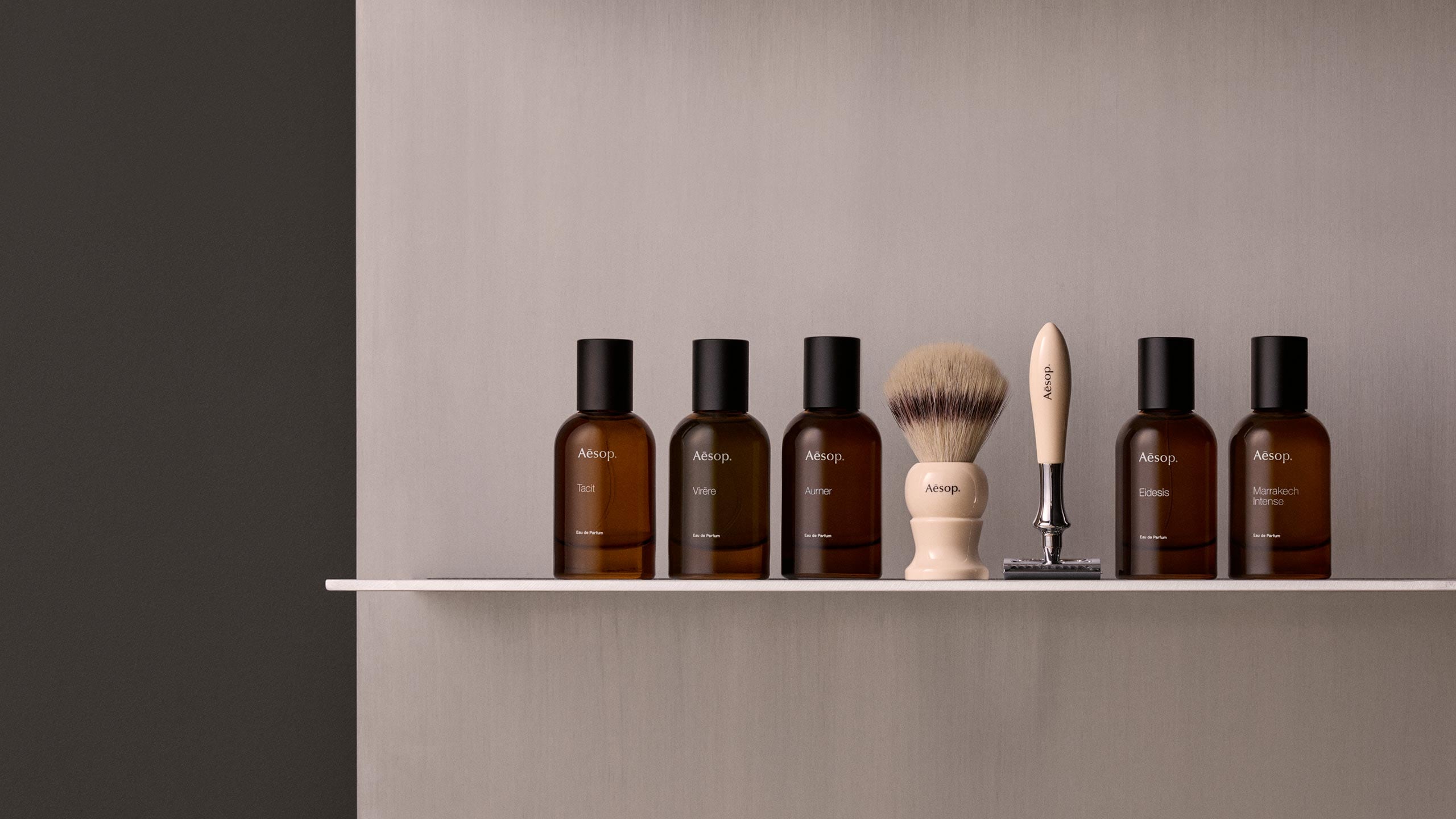 Aesop fragrances and razor on shelf.