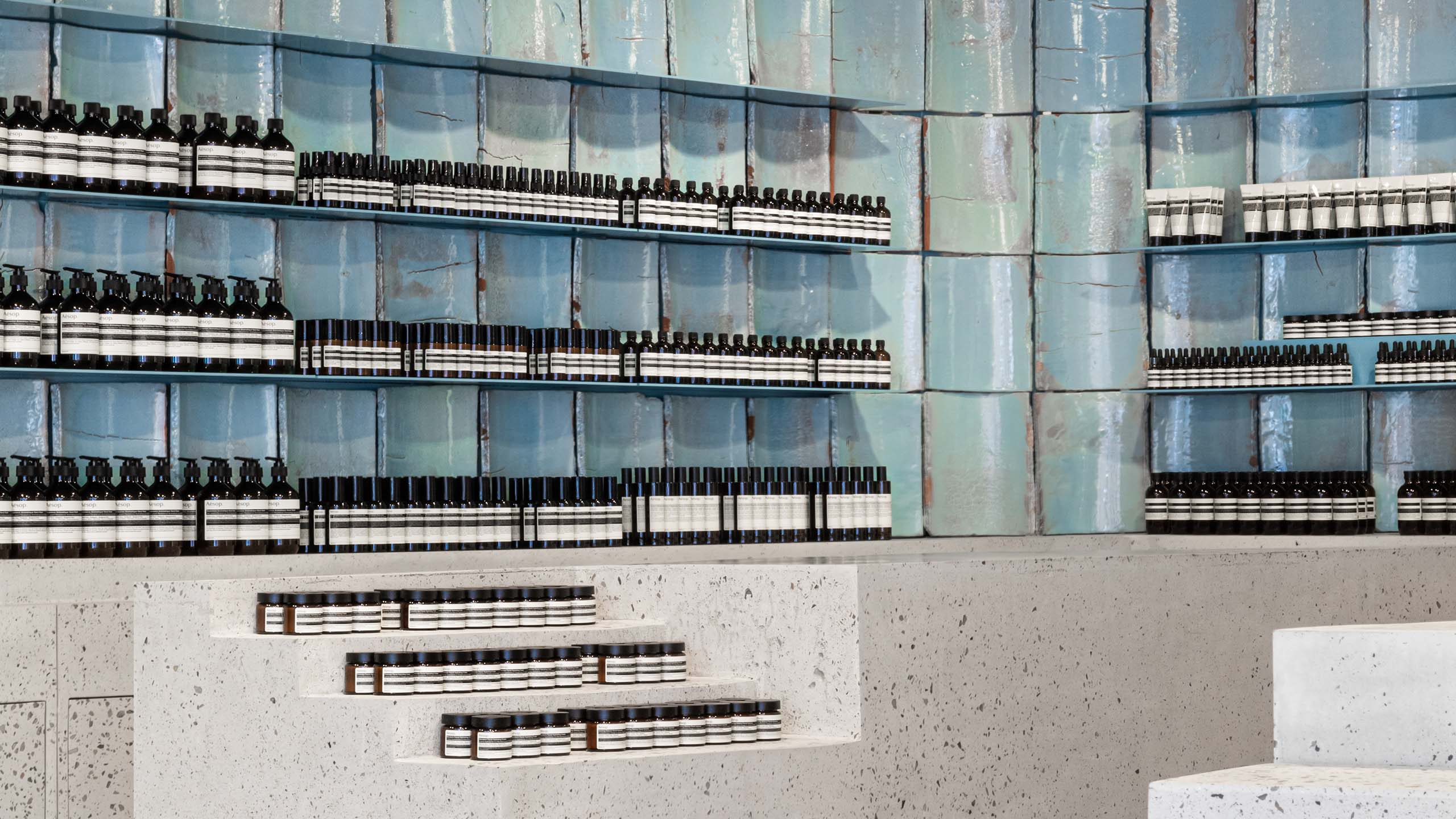 Blue-green tiles have been presented as exhibits along the back wall with products display in the front