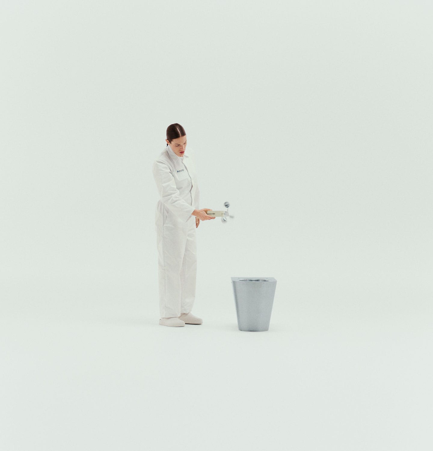 A scent supervisor using a gadget to scan the toilet.
