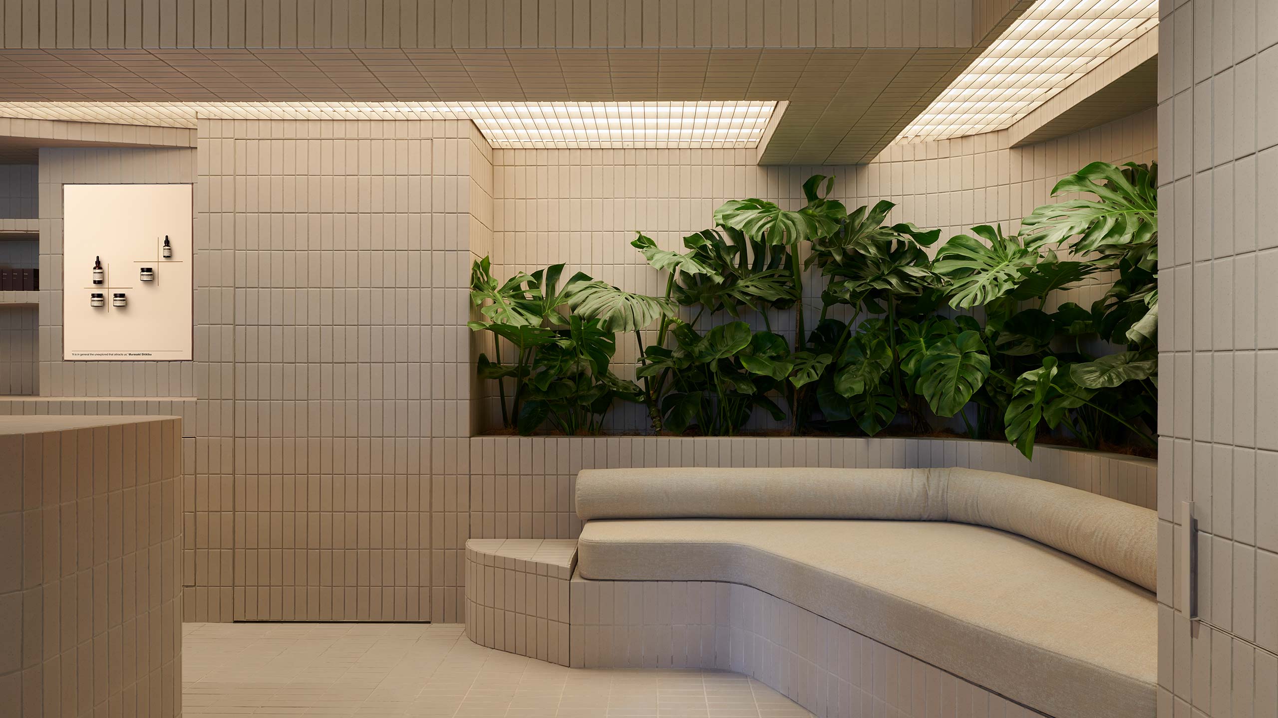 Aesop Hollywood Road store interior with a couch and surrounded by plentiful planter