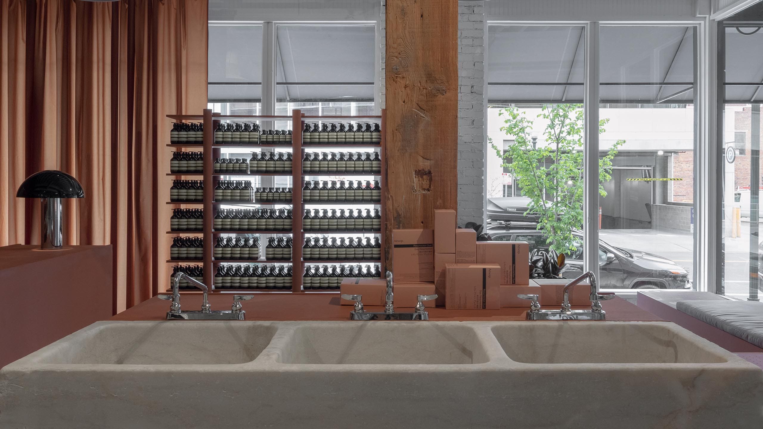 Concrete coloured sinks contrasting with sienna shelving.