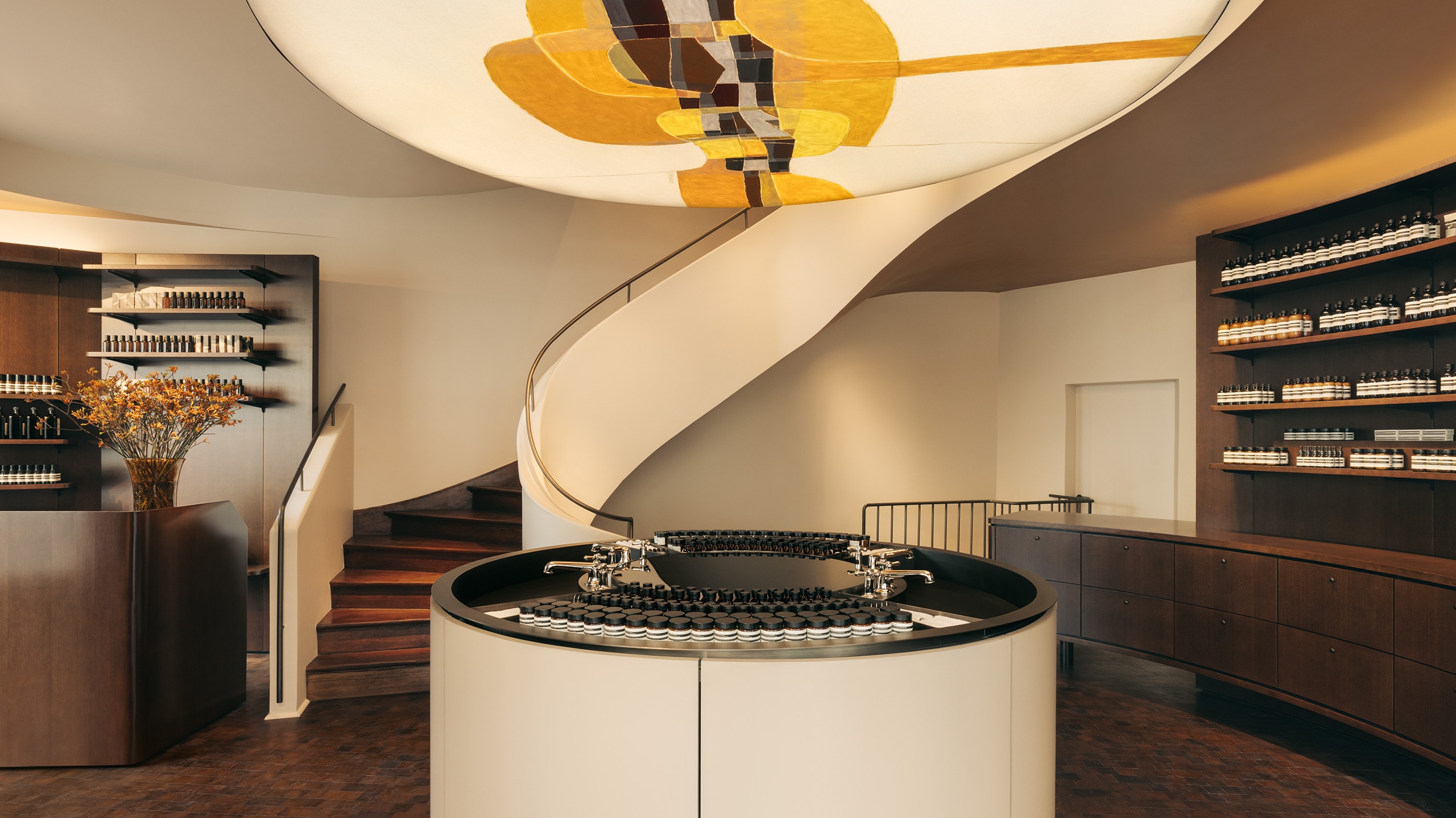 Aesop Rue de Sèvres store interior light fixture and winding staircase.
