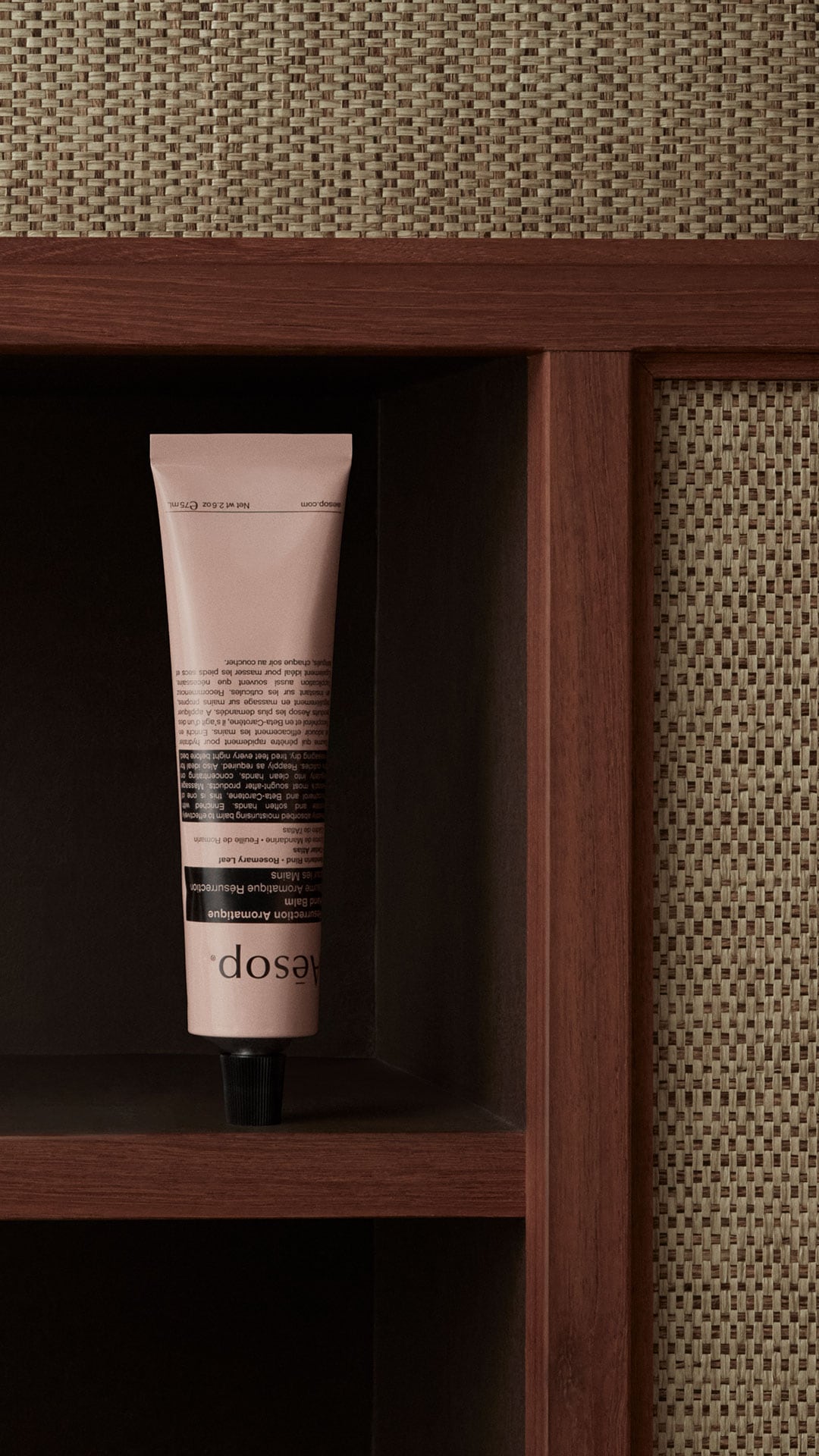Resurrection hand balm in tube placed on a wooden shelf