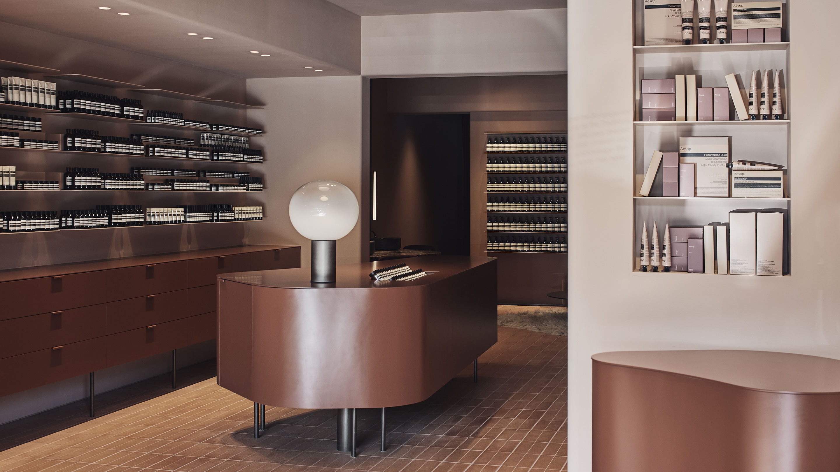 Aesop Mosman store interior, featuring products on a brown desk and shelves