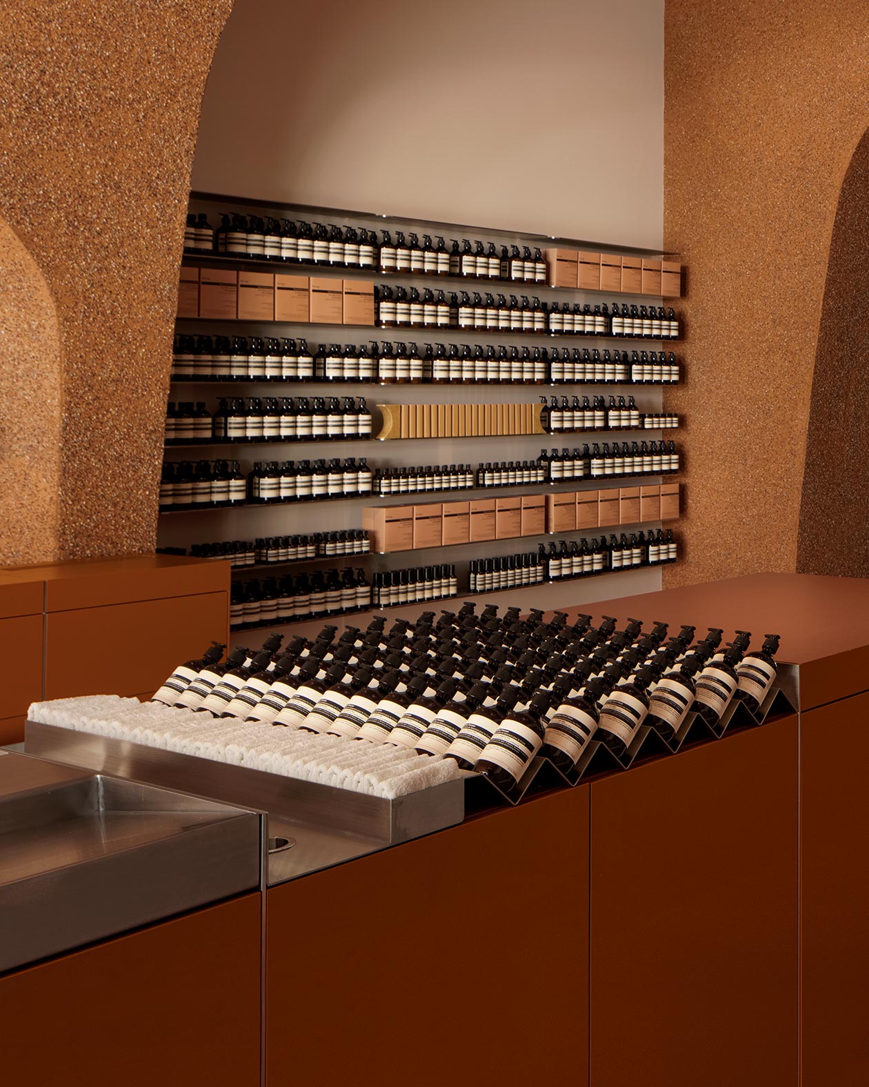 Aesop Southland interior showing Aesop product placed on shelves and benchtop next to a sink