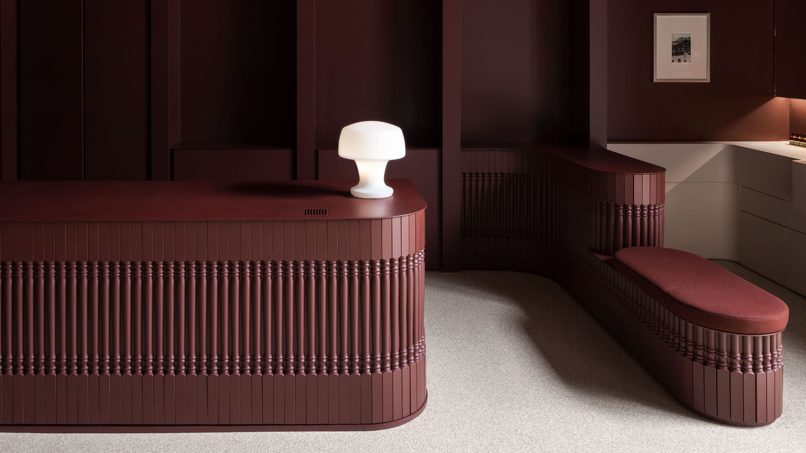 Deep, rich plum-colored counter top with a white mushroom lamp illuminating on the right side.