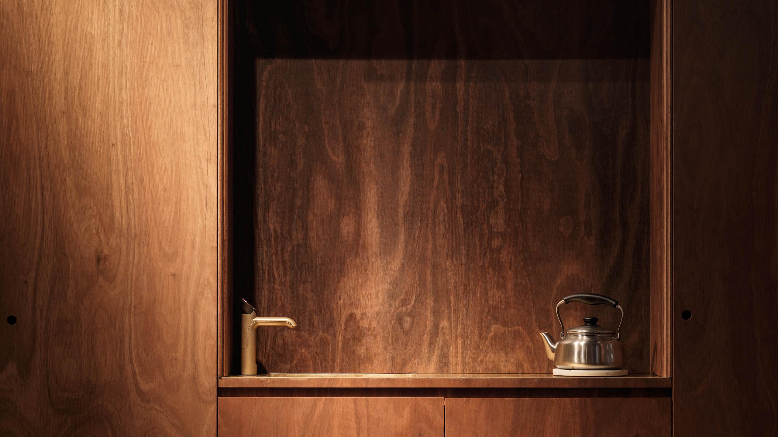 A close-up of the store's tea service counter, featuring a steel tea kettle.