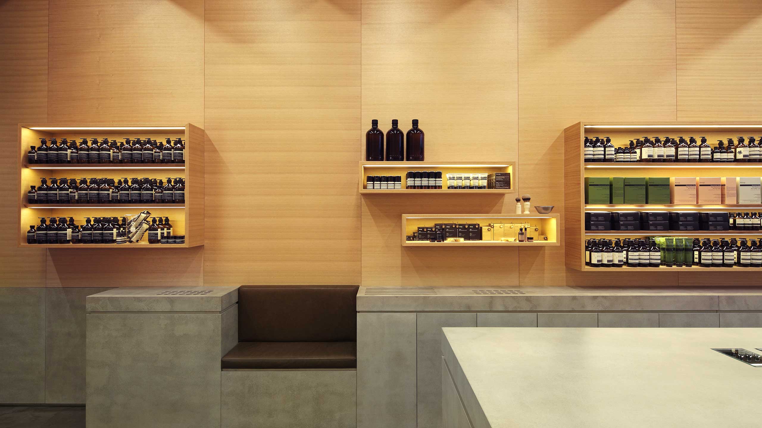 A view of the smooth, grey counter and the bright, wooden wall.