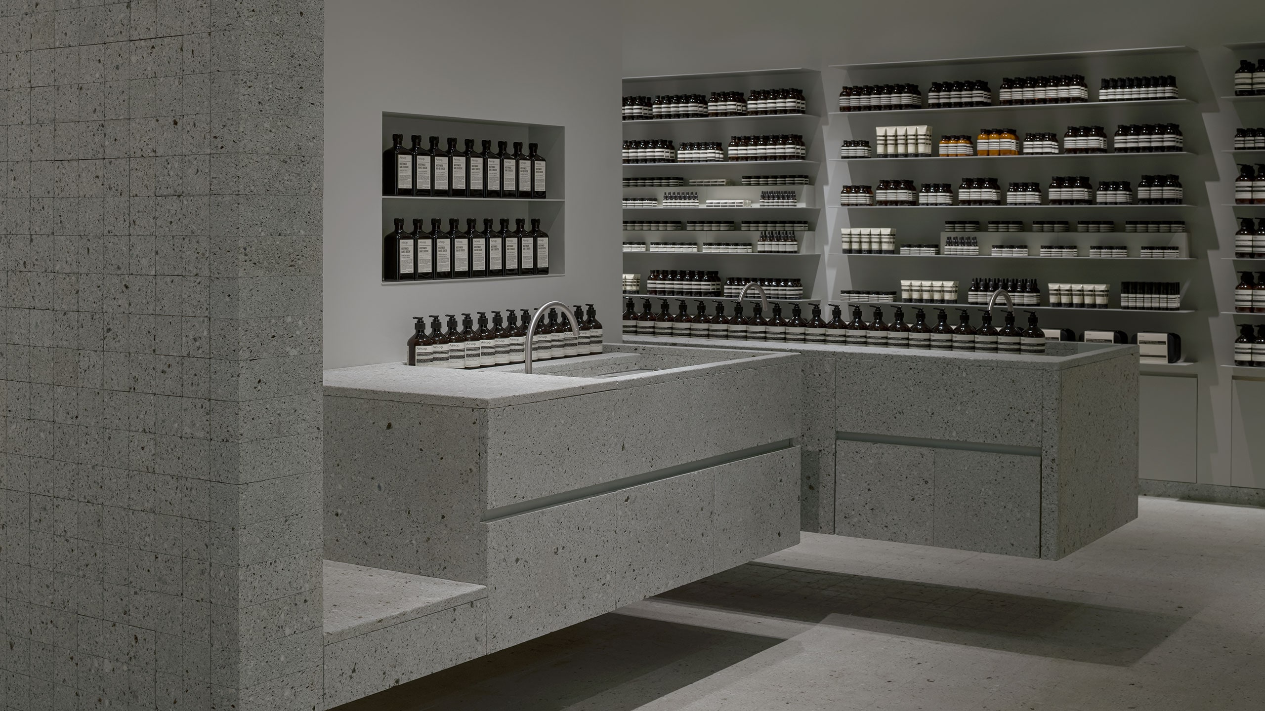 The cantilevered product display slabs visible and the basins that levitate within. 