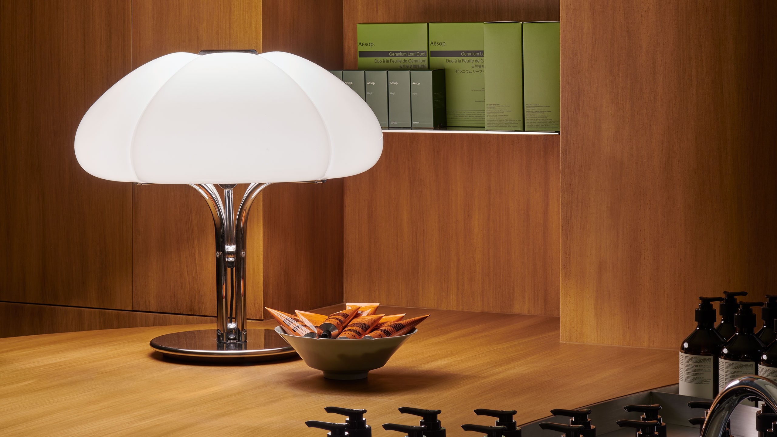 Aesop Hysan Place store interior featuring a vintage chrome-footed lamp