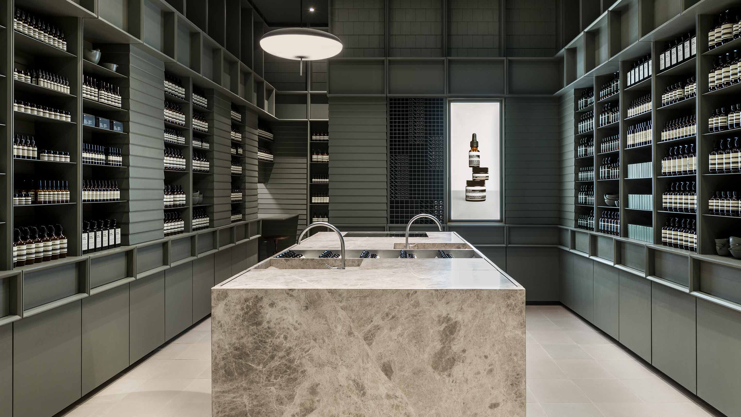 Aesop San Francisco Centre store interior, overlooking large marble basin and architectural chair