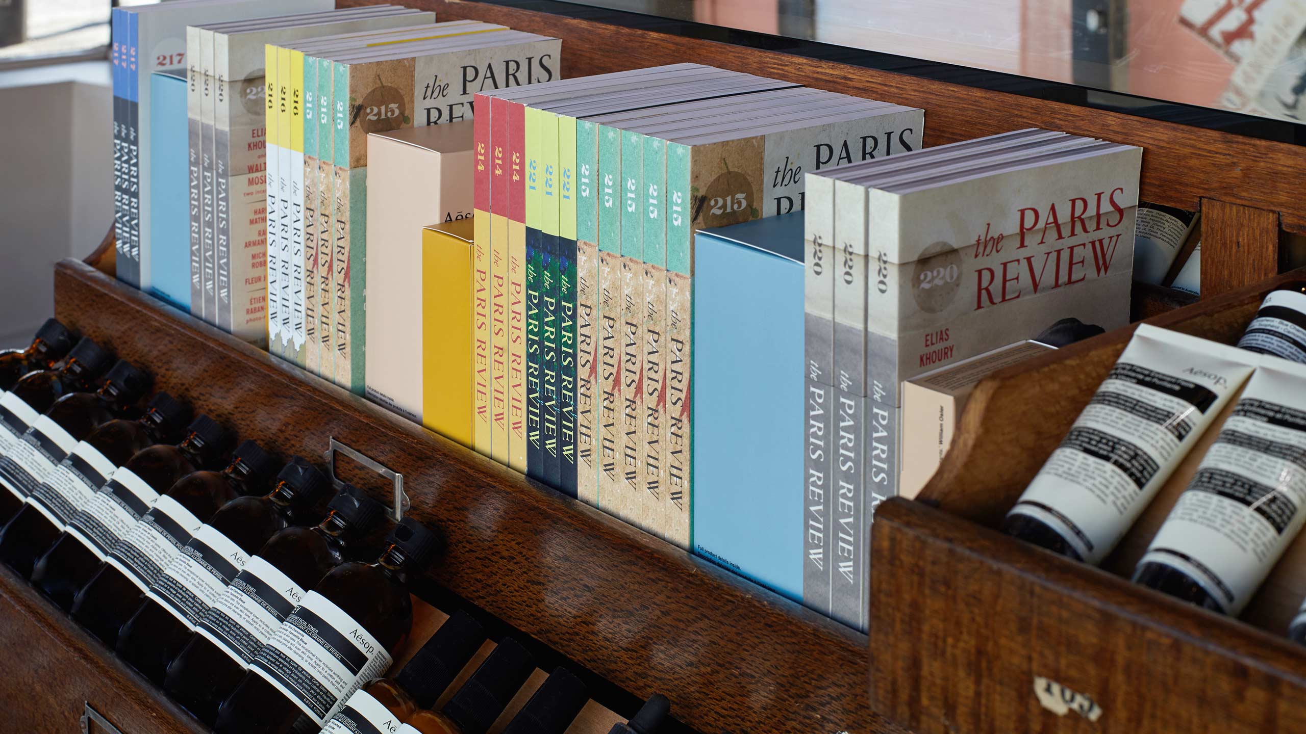 A collection of The Paris Review editions, featured on a shelf alongside Aesop products.