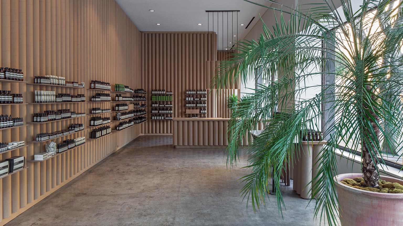 A concrete shop floor fitted with walls made from cylinder cardboard tubes.