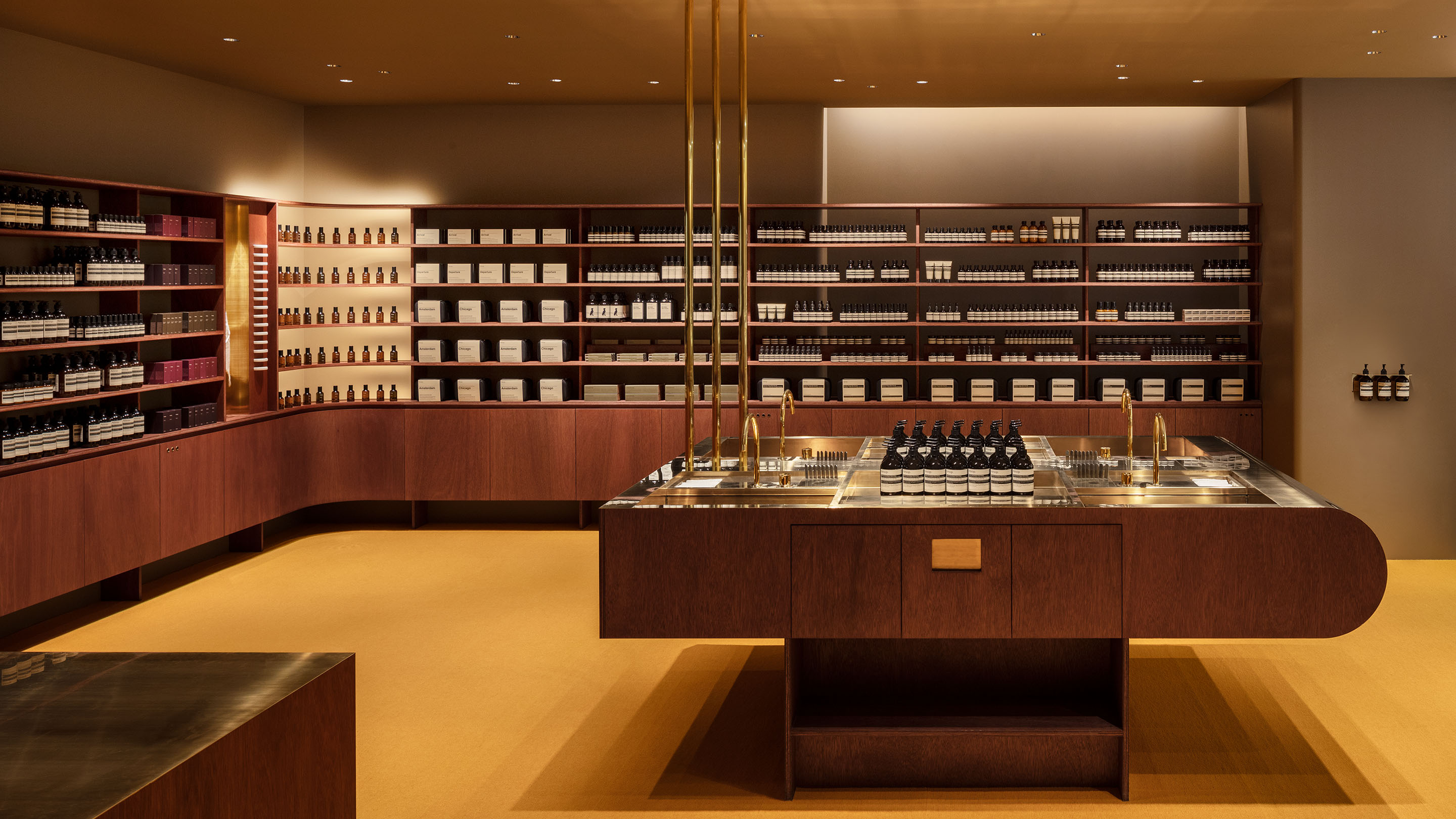 Aesop Kyoto Takashimaya store shelving and cupboards are rendered in dark stained rawan veneer