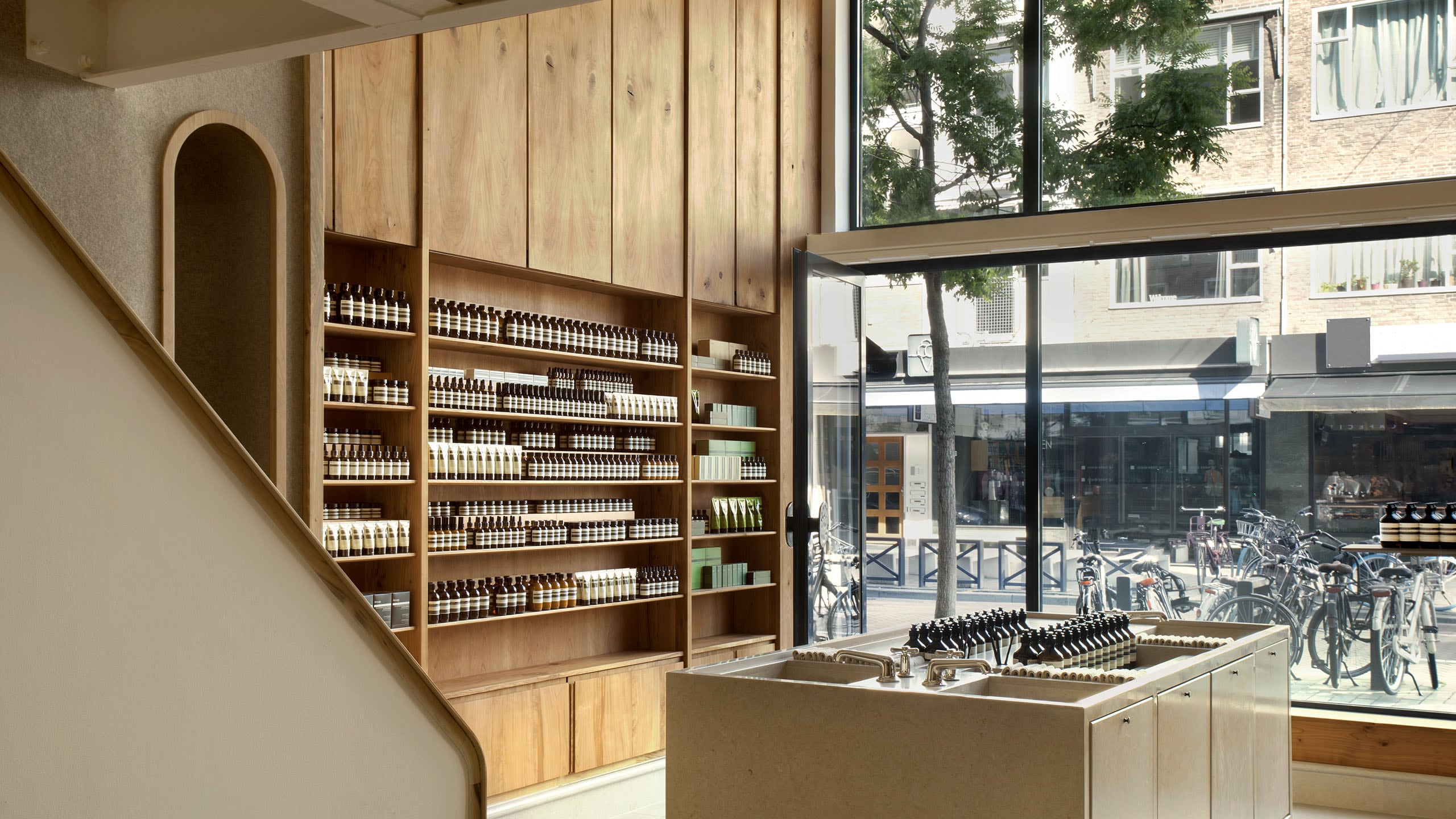Aesop De Meent store interior shelving and amber bottle displays.