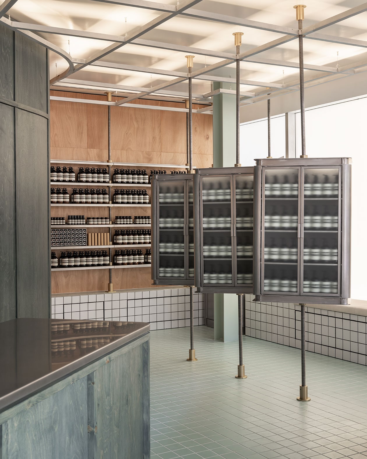 Aesop products on wooden shelves and metallic cabinets in Aesop Booragoon store