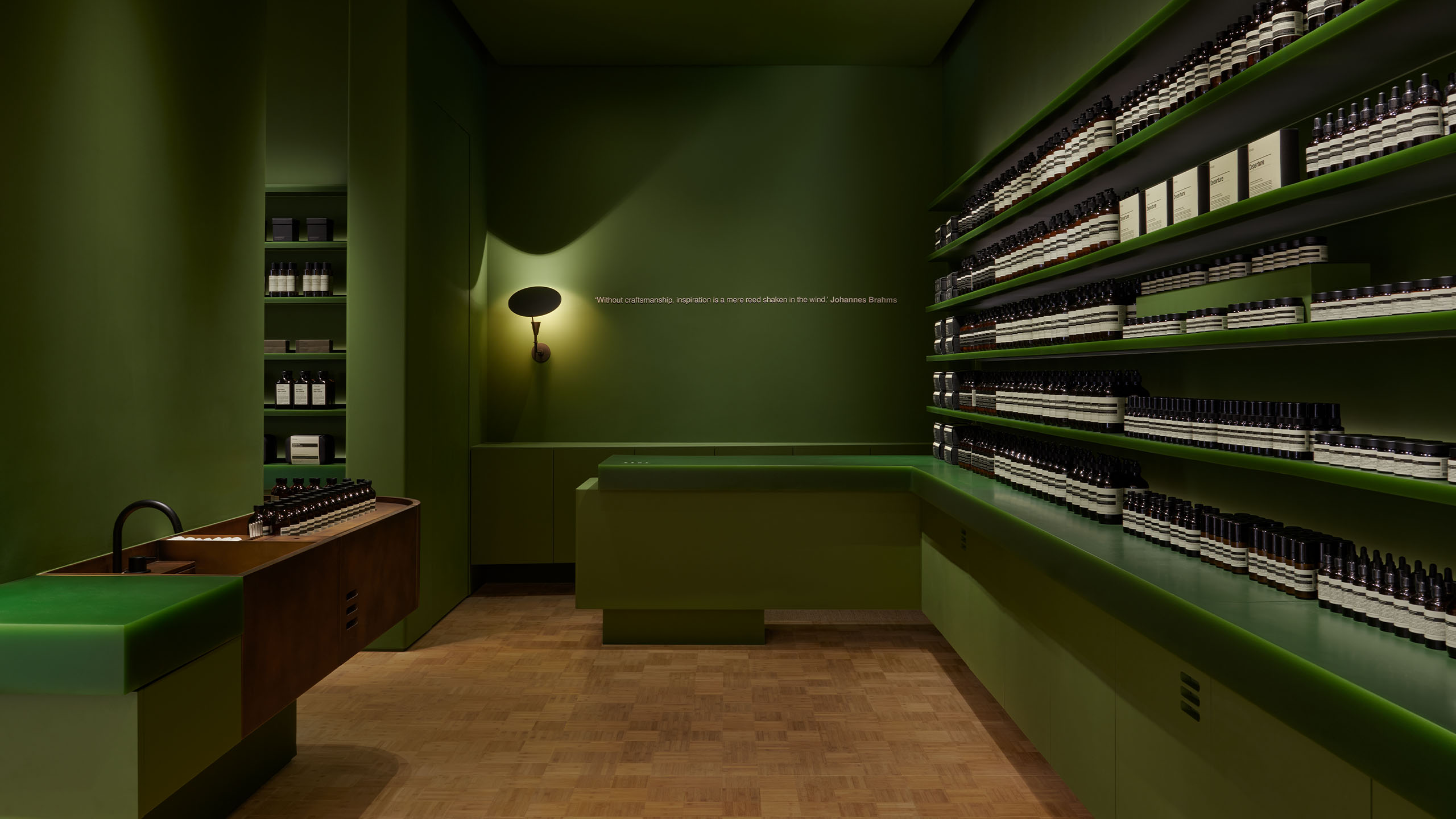A Mahjong green interior and semi-translucent shelves with Aesop products