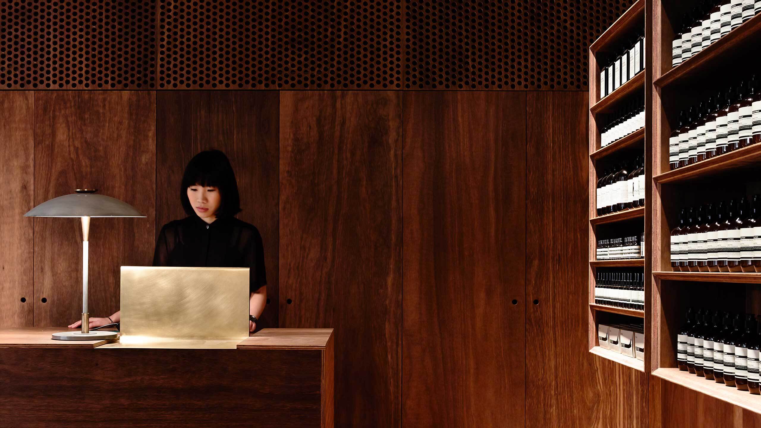 An Aesop consultant using a computer at a counter