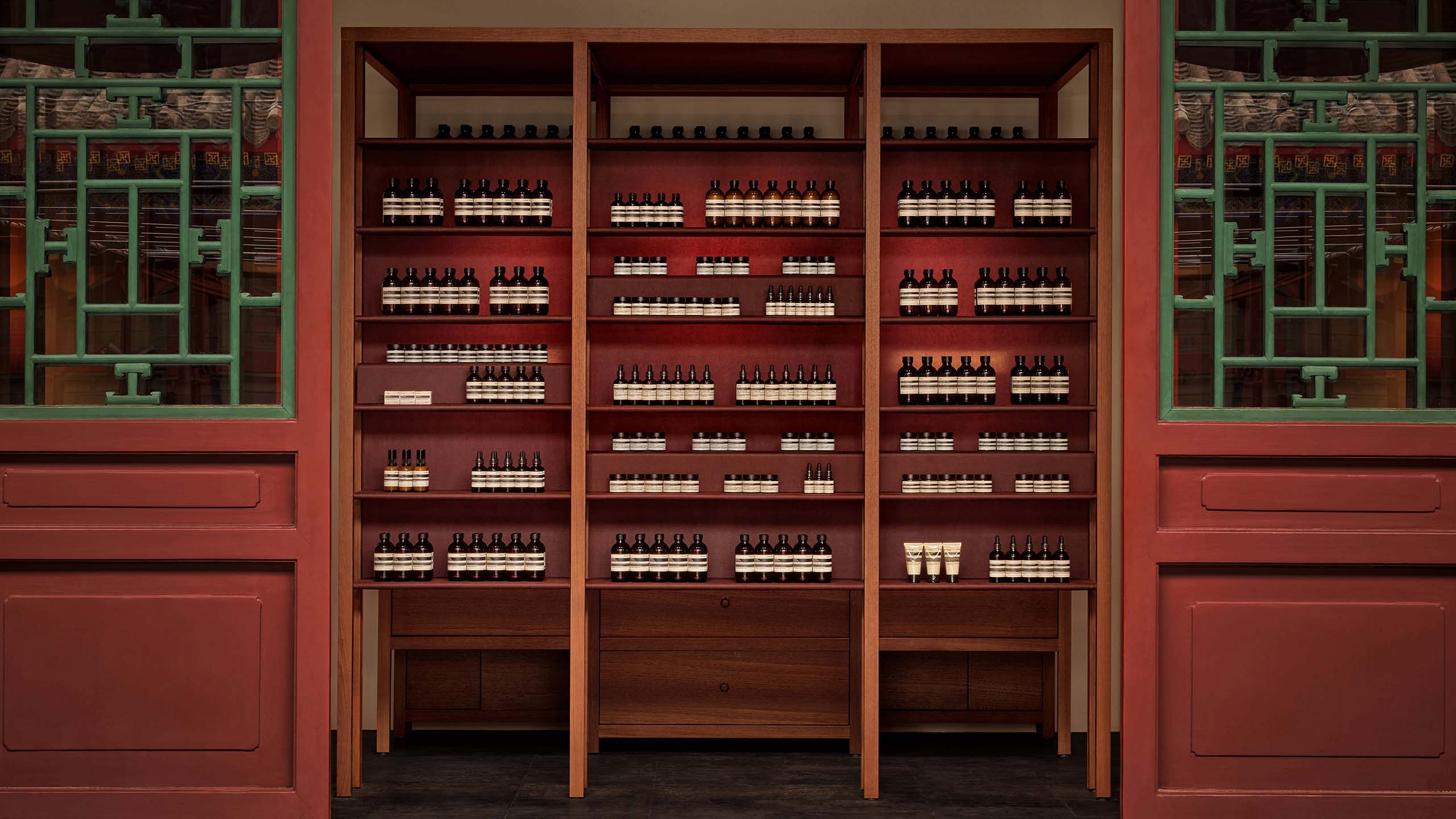 High ceilings and wooden rafters with Aesop products on the wooden shelves 