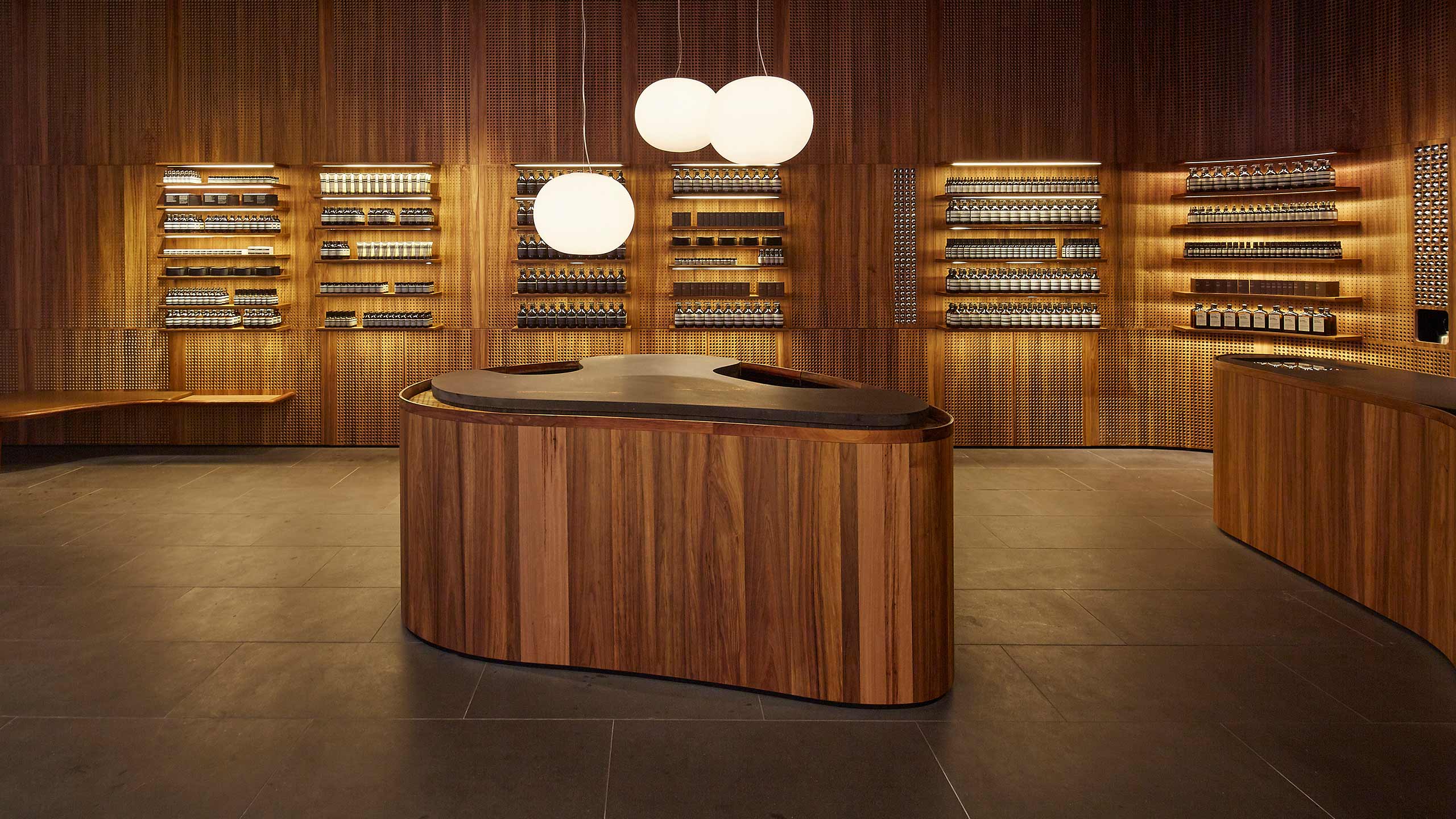 A close-up of the curved wooden customer service desk.