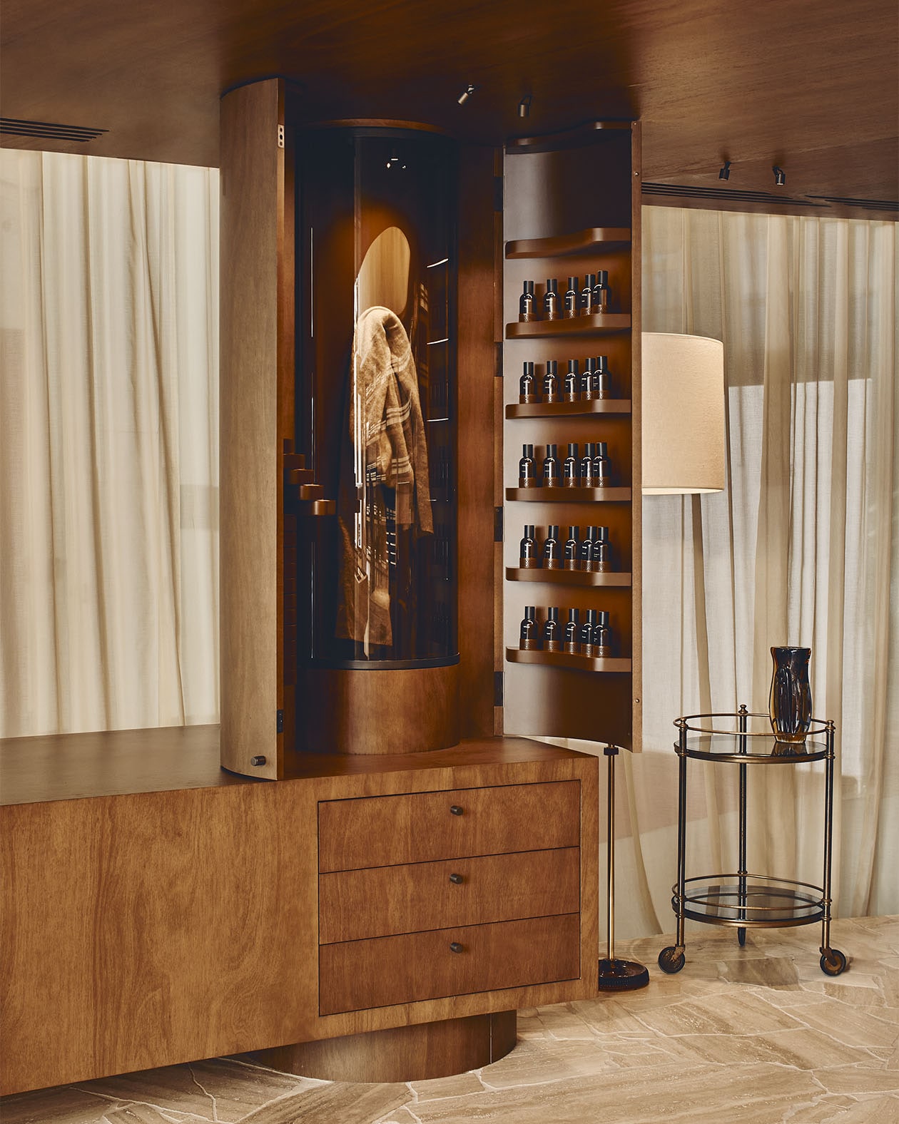 A Fragrance Armoire made from Australian Blackbutt timber displaying a collection of Aesop Fragrance bottles.