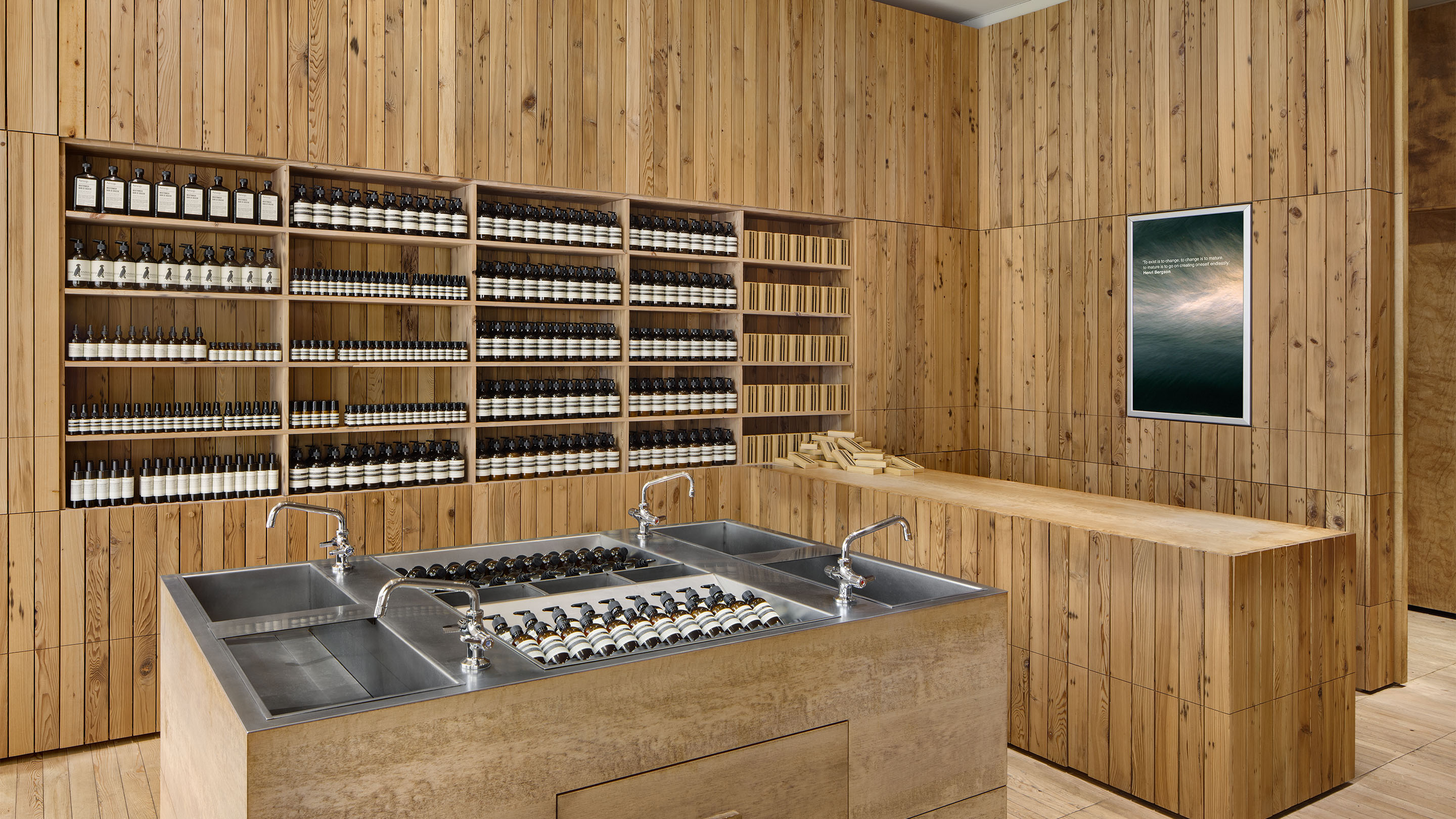 A store counter made from reclaimed timber; steel sink displayed in the centre