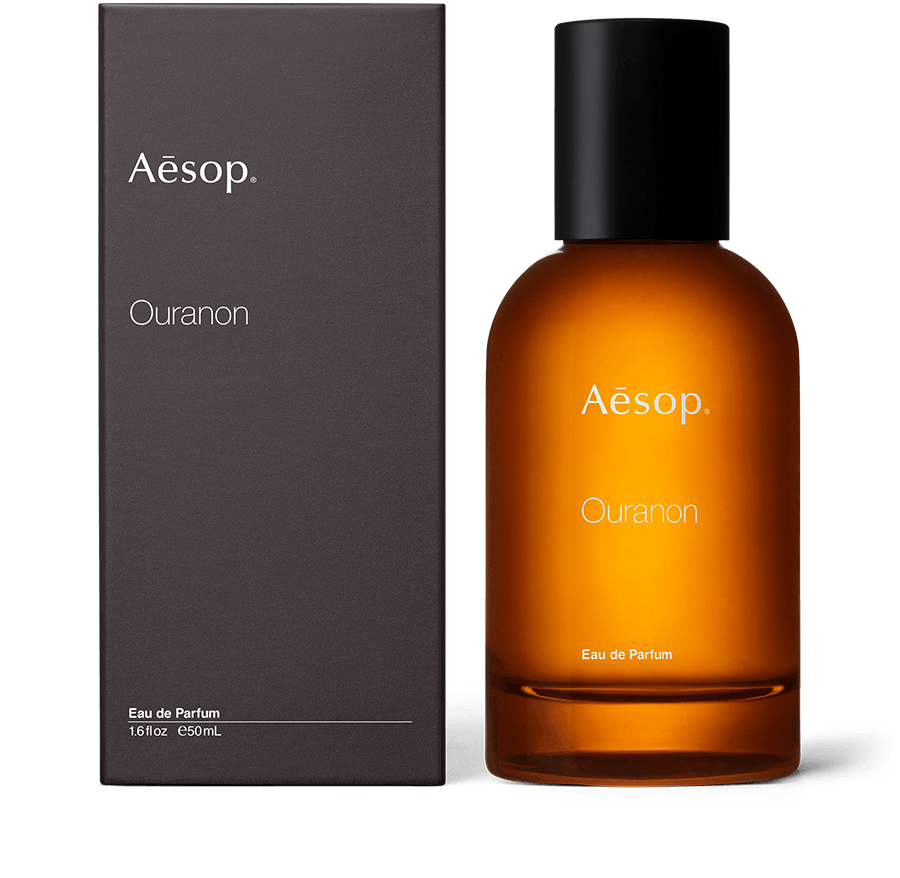 An amber bottle of Ouranon Eau de Parfum alongside carton packaging. 