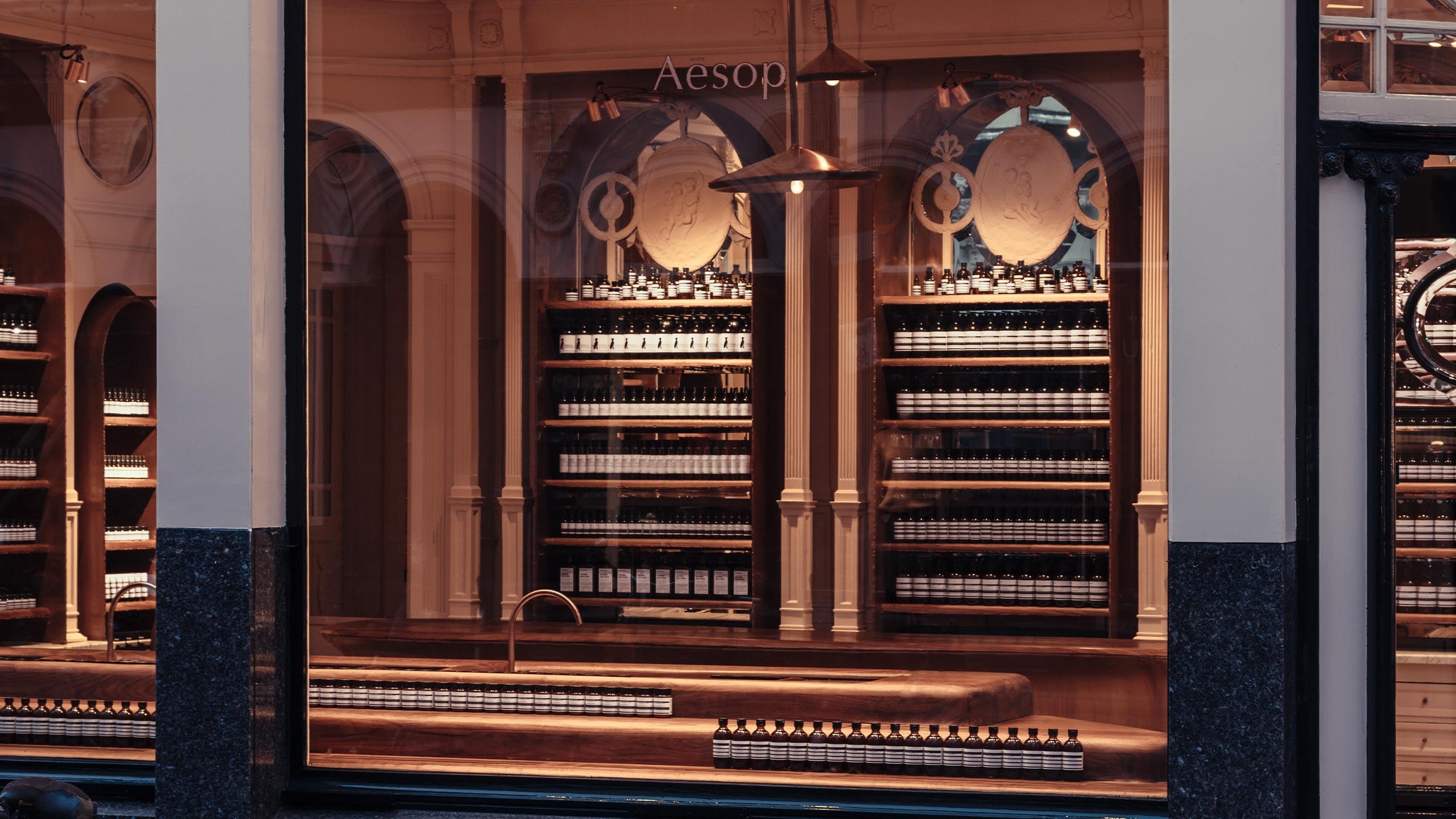 Aesop Utrechtsestraat store interior shelves through window