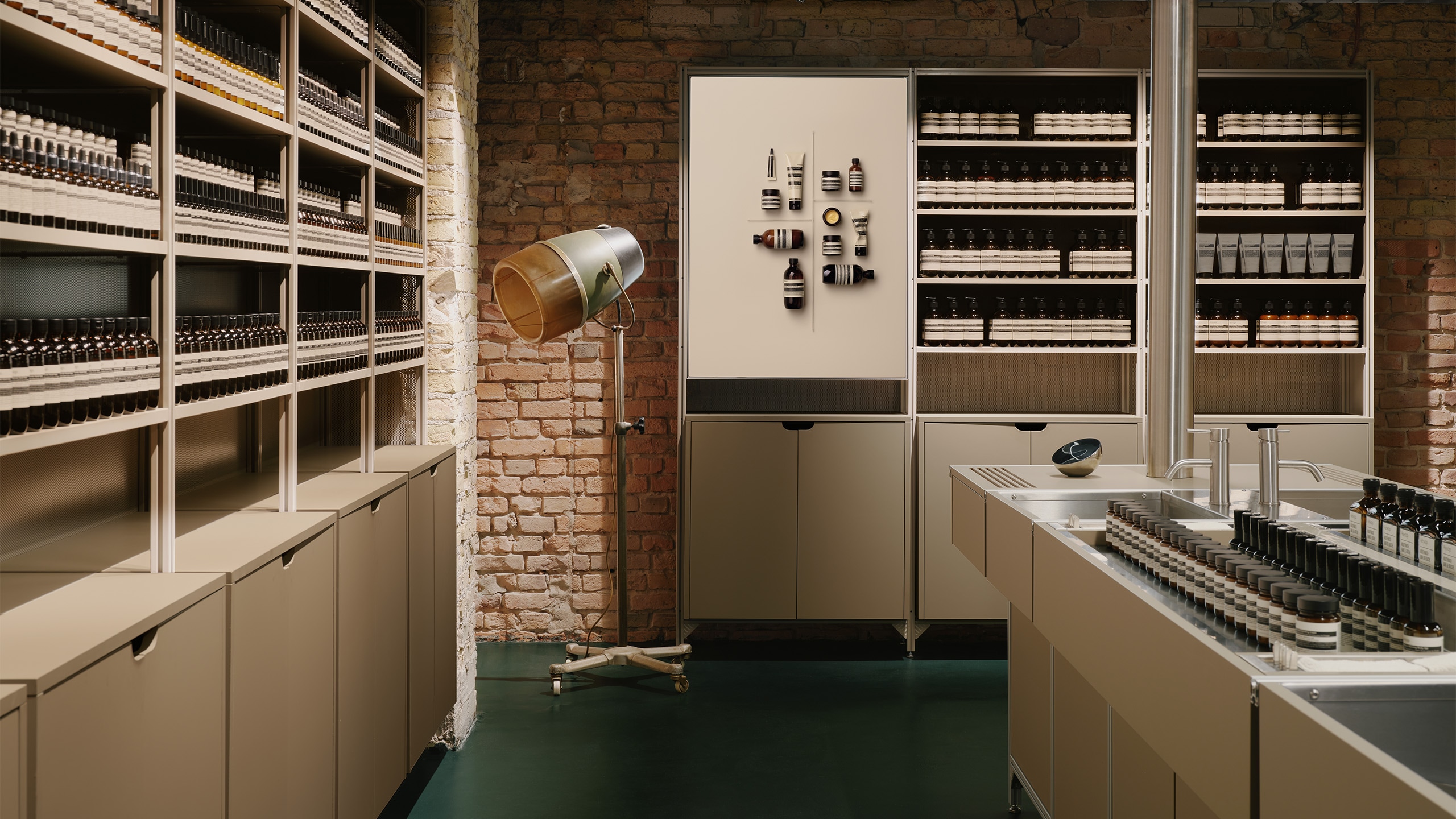 Aesop Kurfurstendamm store interior featuring standing lamp, basin and product display