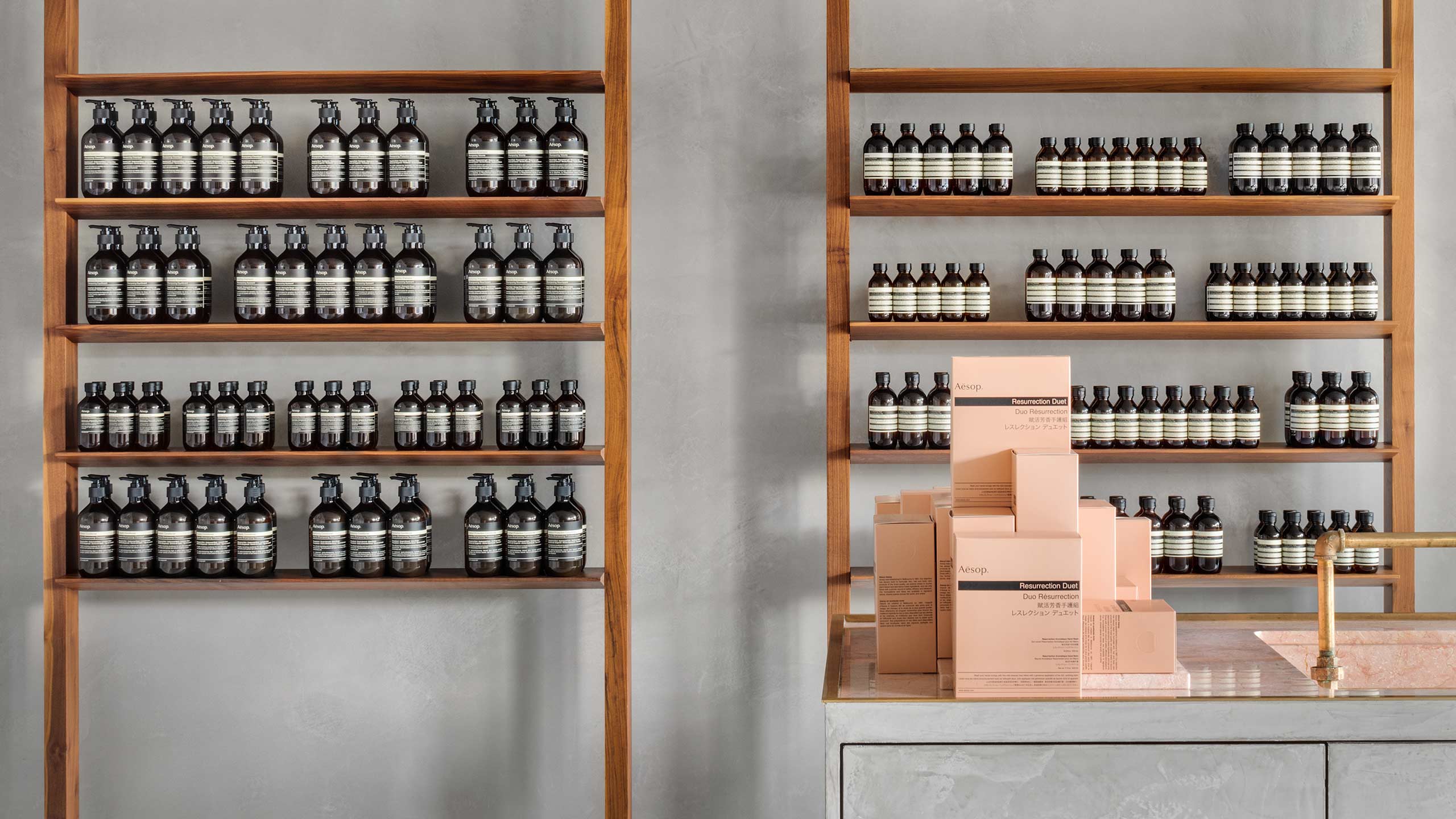 Aesop Resurrection Duet variously stacked on top of one another on a marble service.