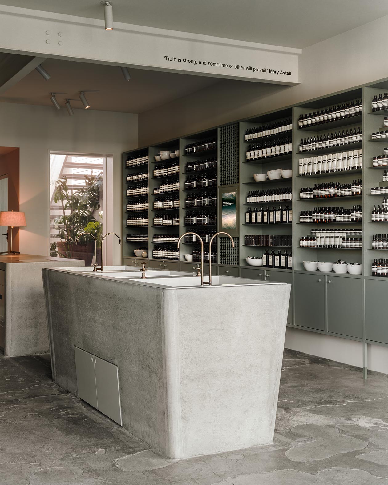 The vintage-laundry-styled concrete basin sits in the middle of the store. On a steel beam running along the ceiling reads the quote: 'Truth is strong, and sometime or other will prevail.'