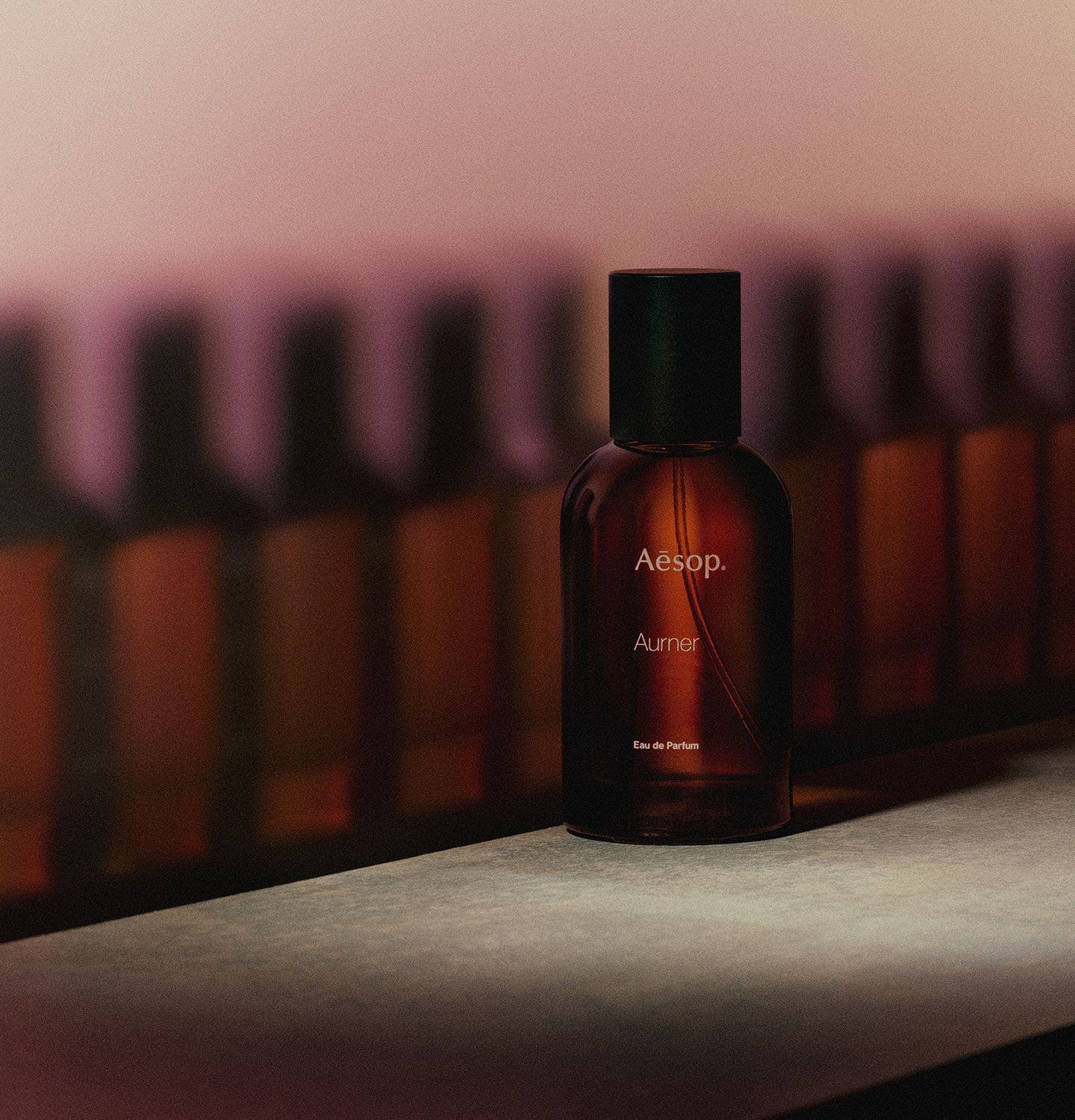 Multiple Aesop fragrance bottles placed behind Aurner EDP bottle