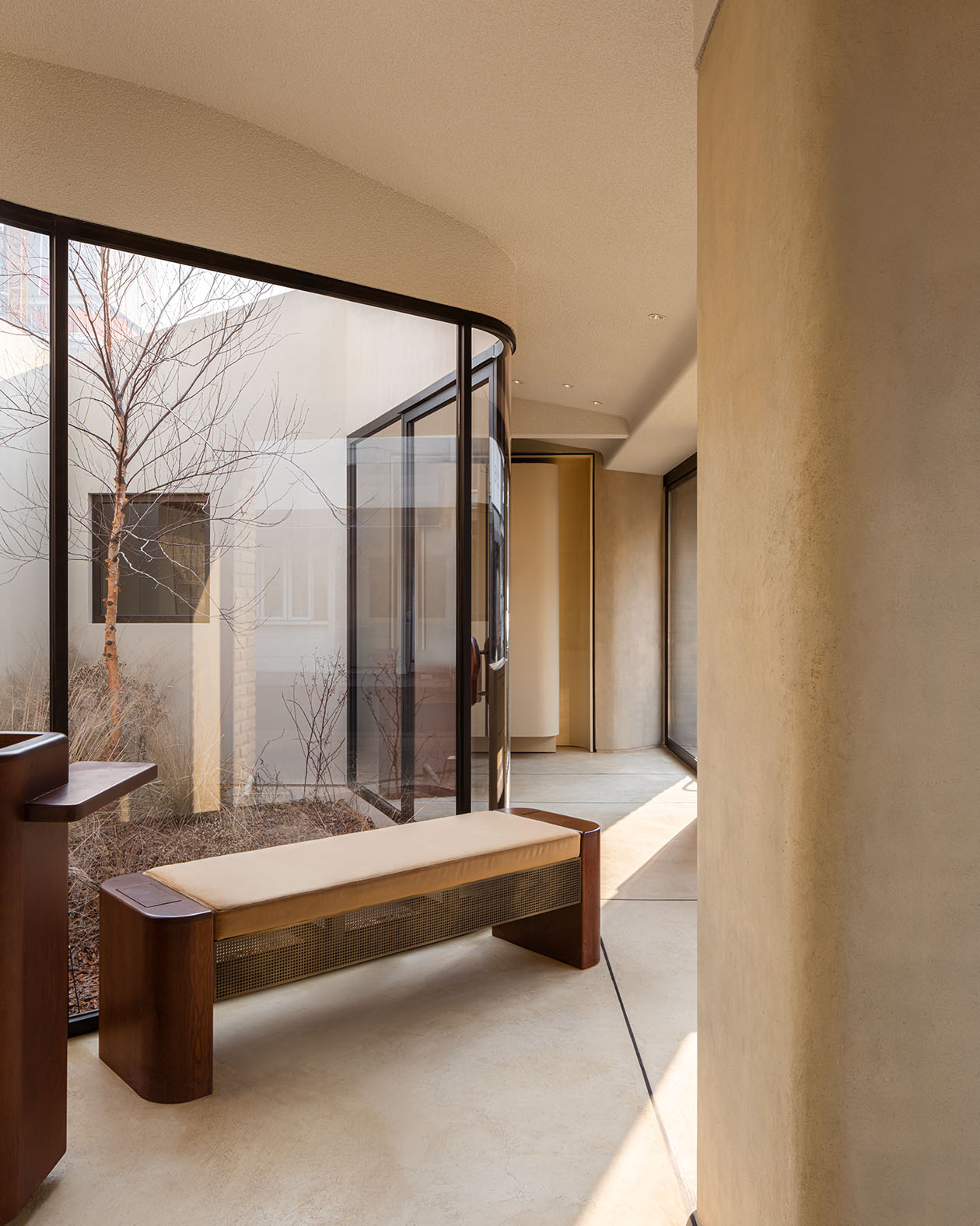 Aesop Seongsu store interior, looking past a bench towards the inner-courtyard.