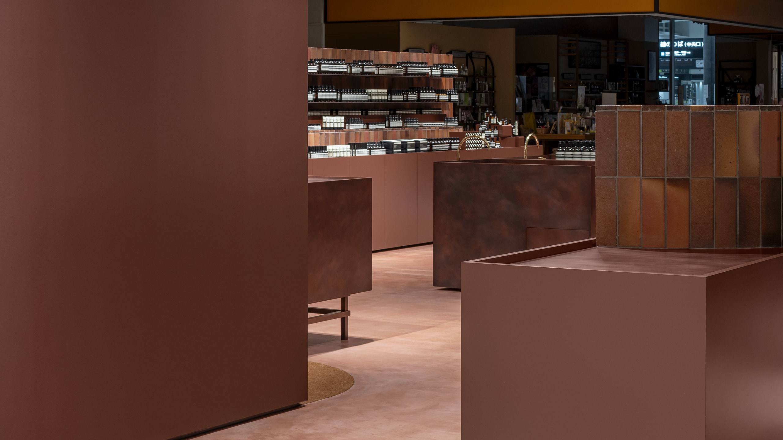 Clay clads the walls and shelves of the store in its rich red-brown colour