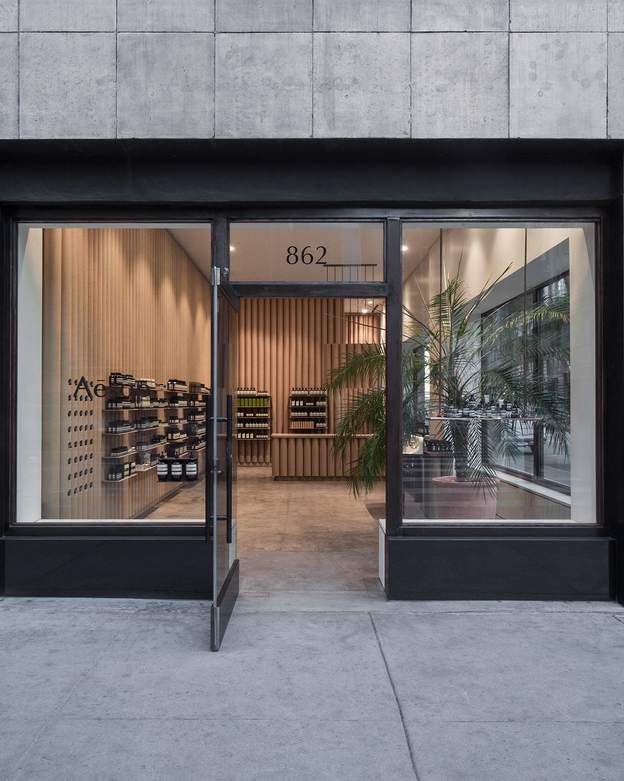 Shopfront of Aesop Downtown LA; a view of the store interior via a large glass door.