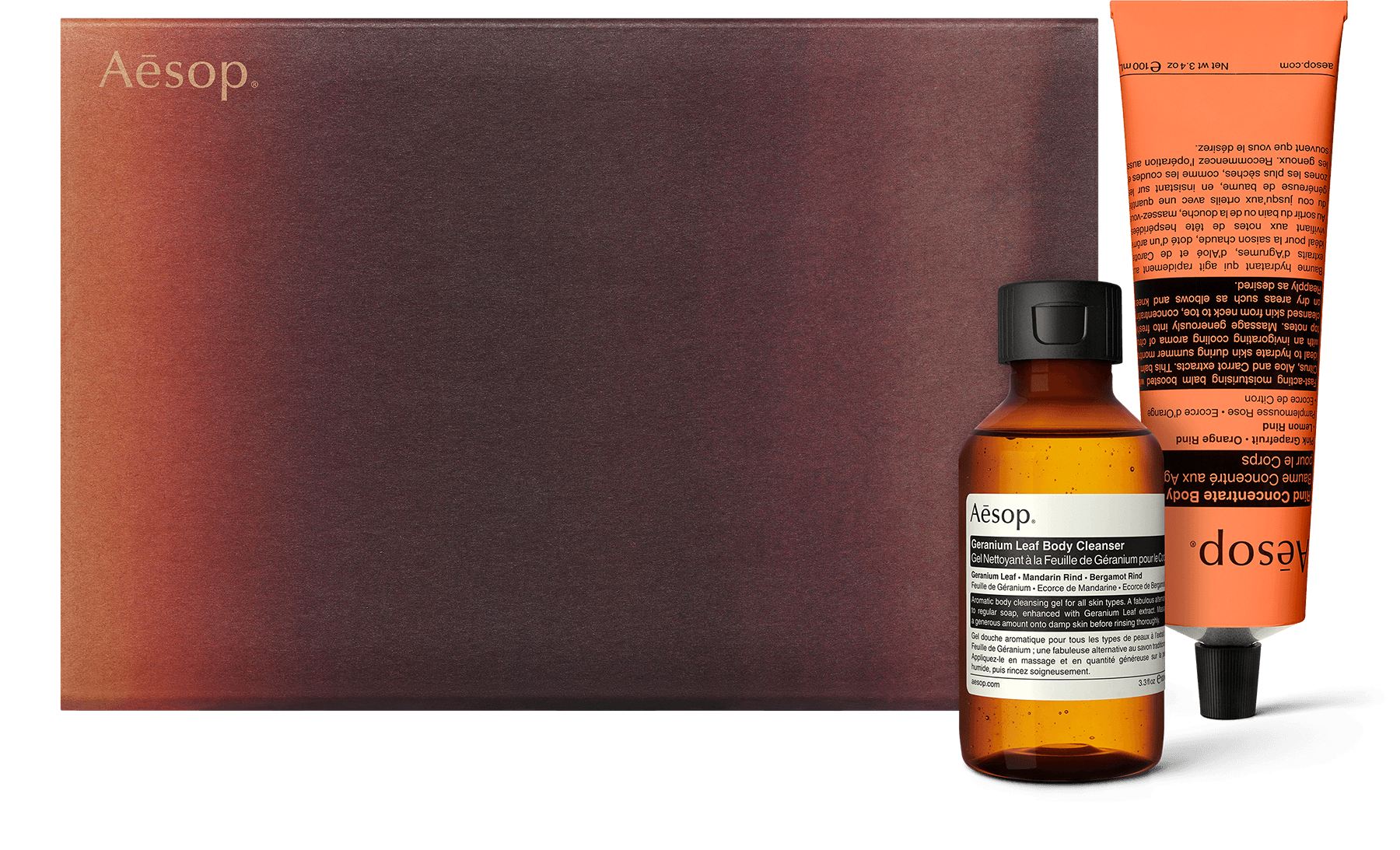A body cleanser and balm alongside a recycled cardboard gift box. 
