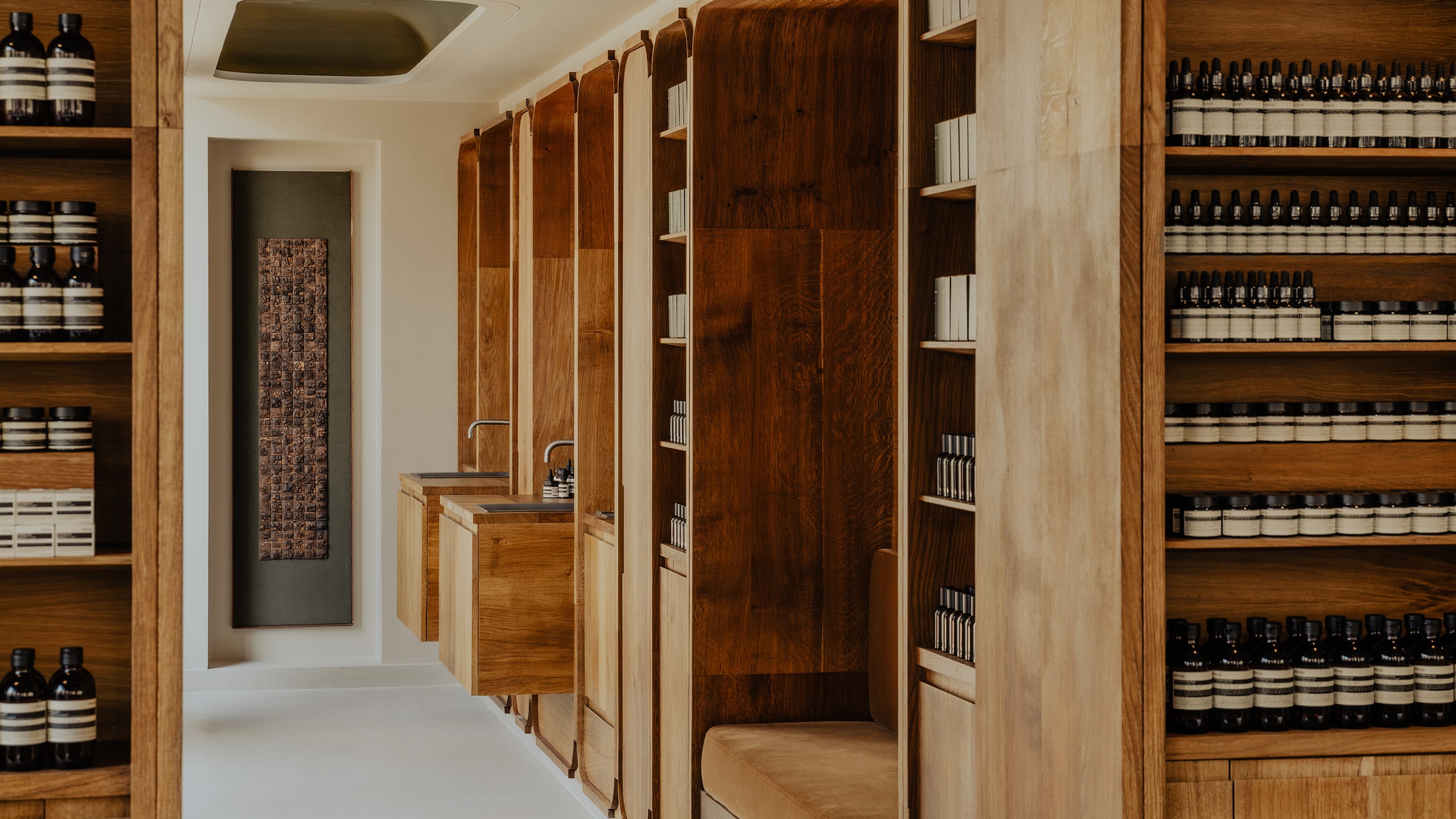 store interior view featuring multiple product shelves with product in foreground and background, with two basins in image background