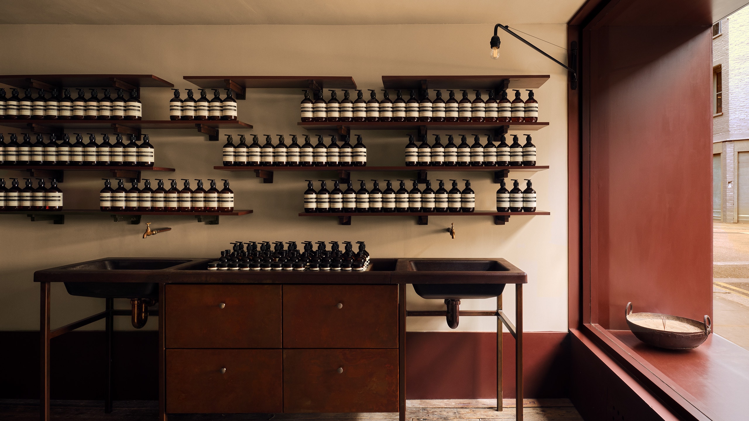 Aesop Shoreditch II store interior window and product shelving display.