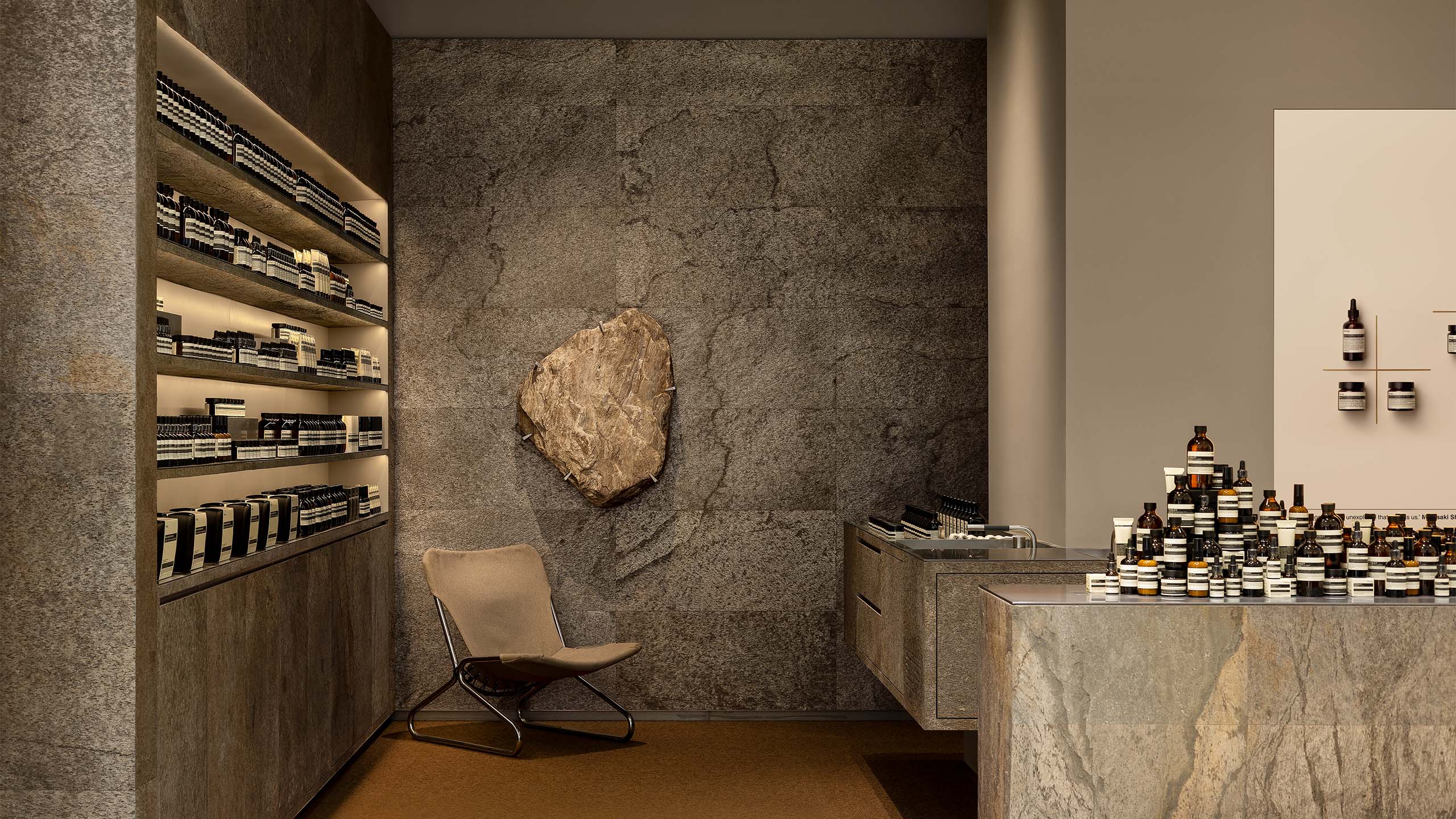 A vintage chair beckons at the back and a shard of the stone hung on the wall