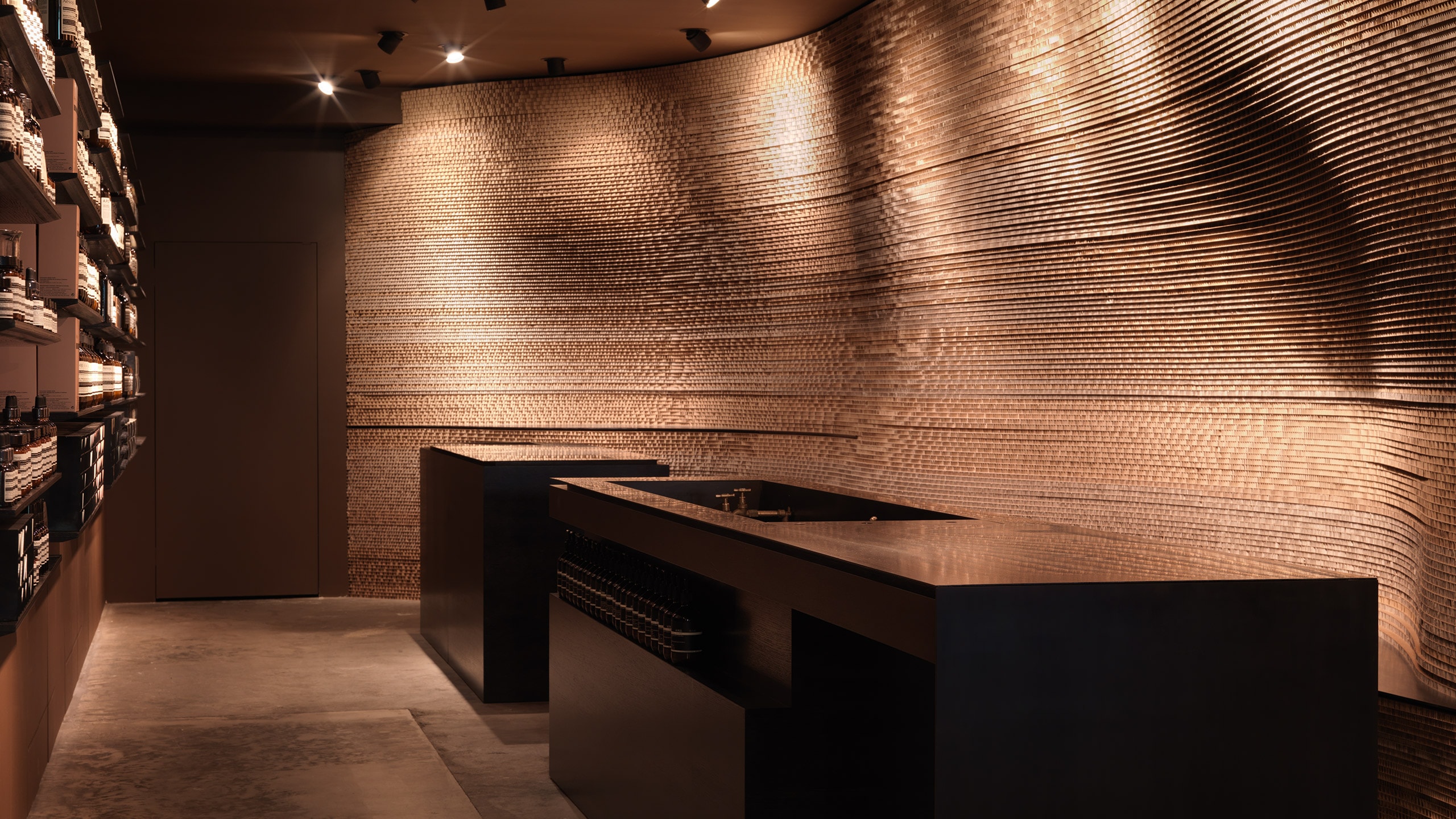The customer service desk constructed out of lacquered oak and blackened steel. 