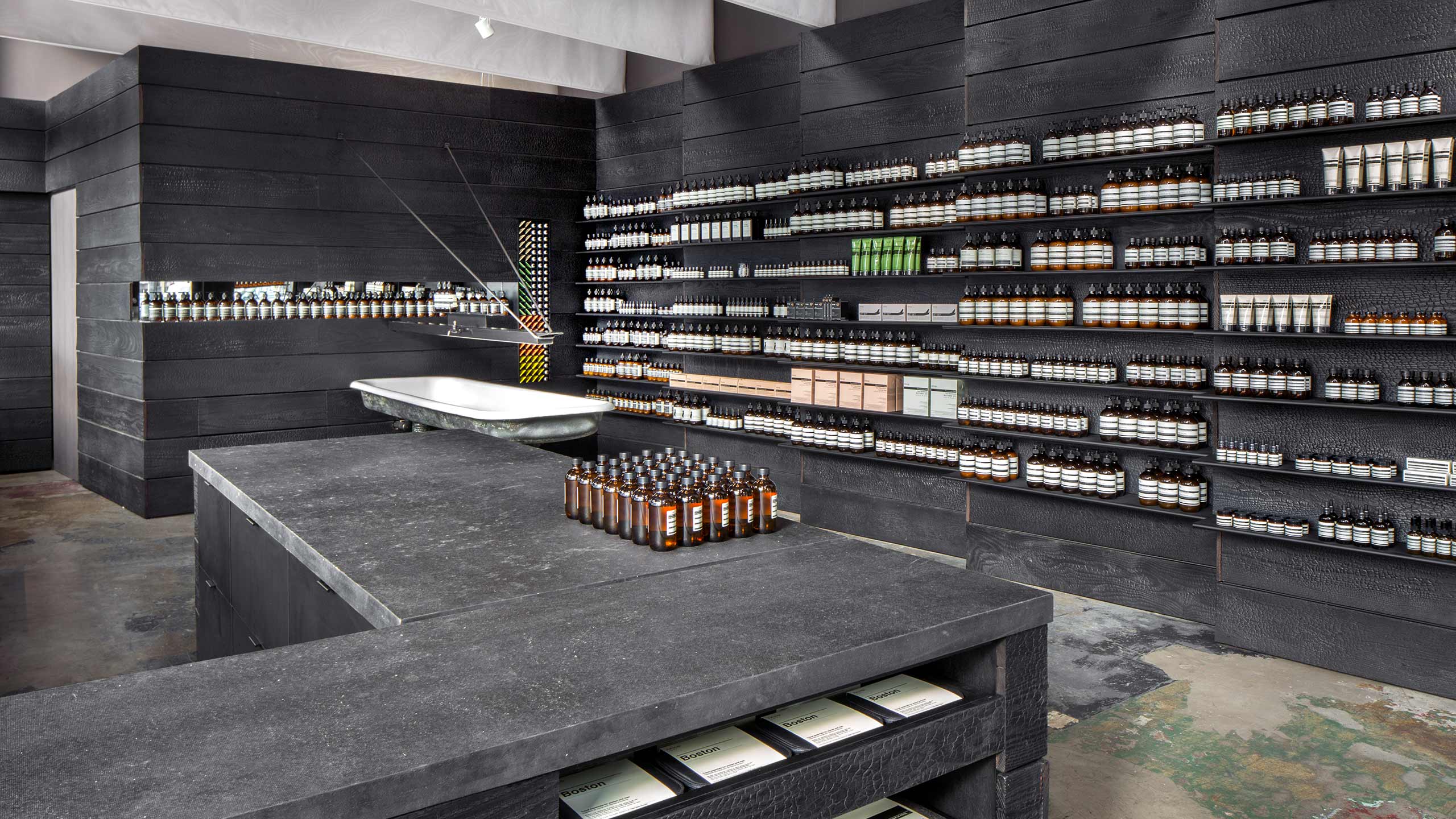 Dark grey counter-top holding amber bottles.